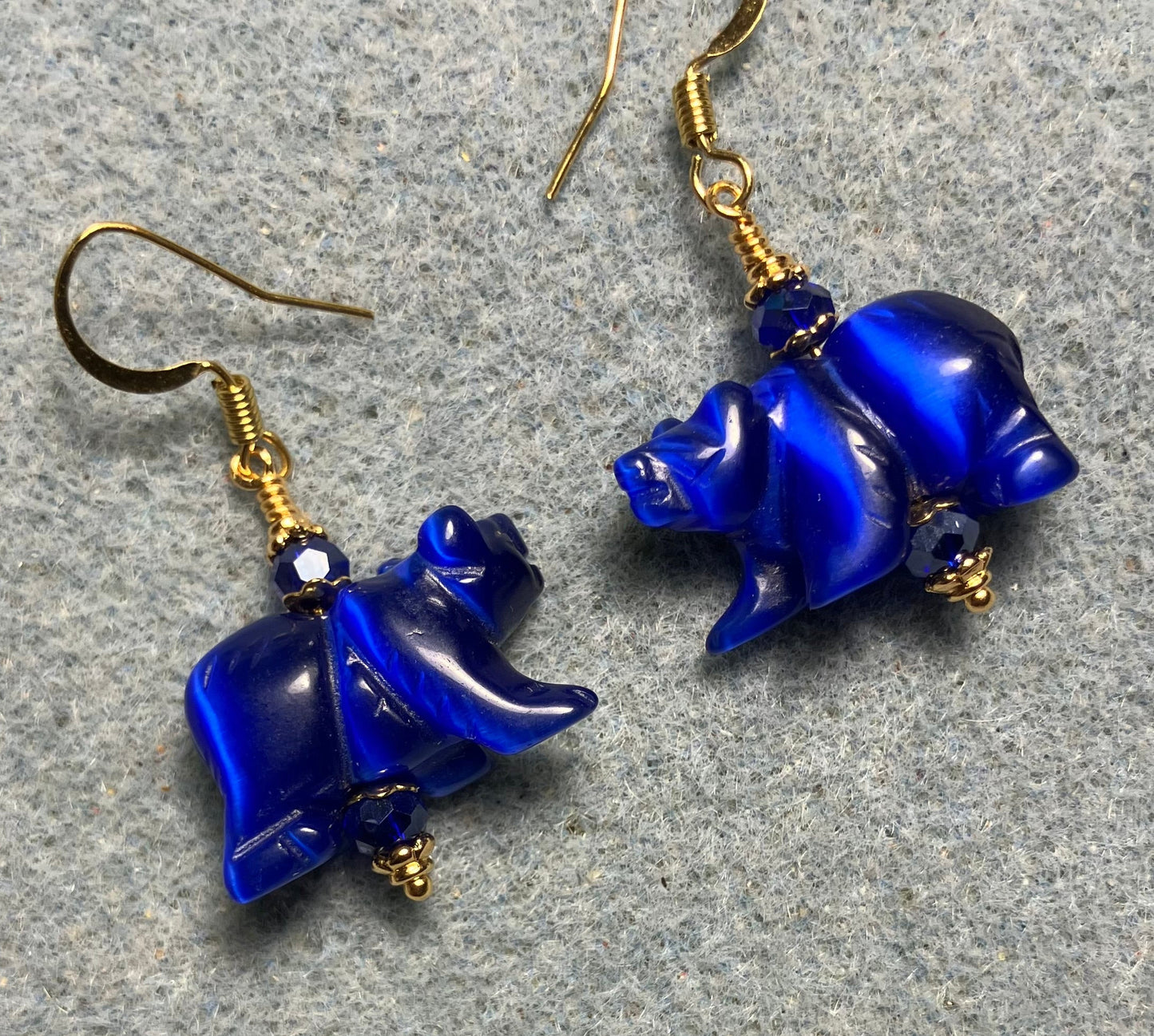 Large dark blue fiber optic (cat’s eye) bear bead earrings adorned with dark blue Chinese crystal beads.