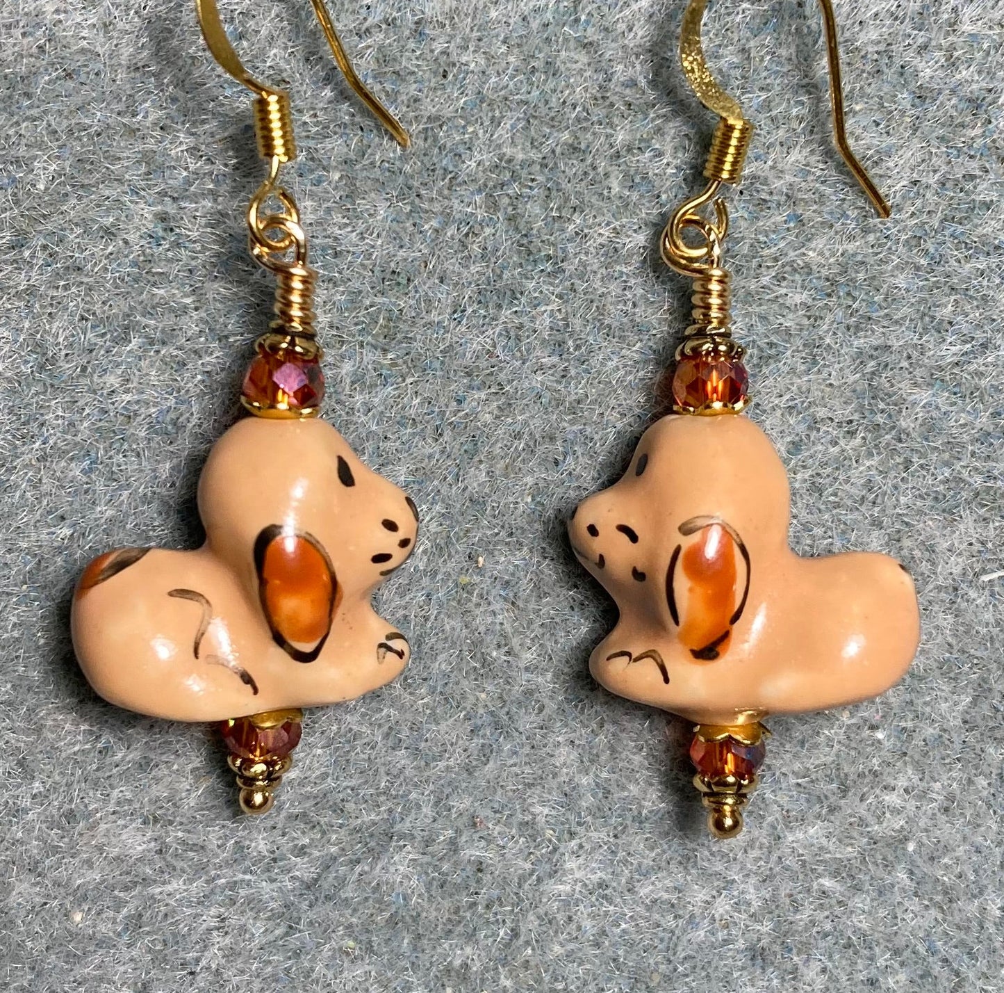 Orange brown ceramic puppy dog bead earrings adorned with orange Chinese crystal beads.