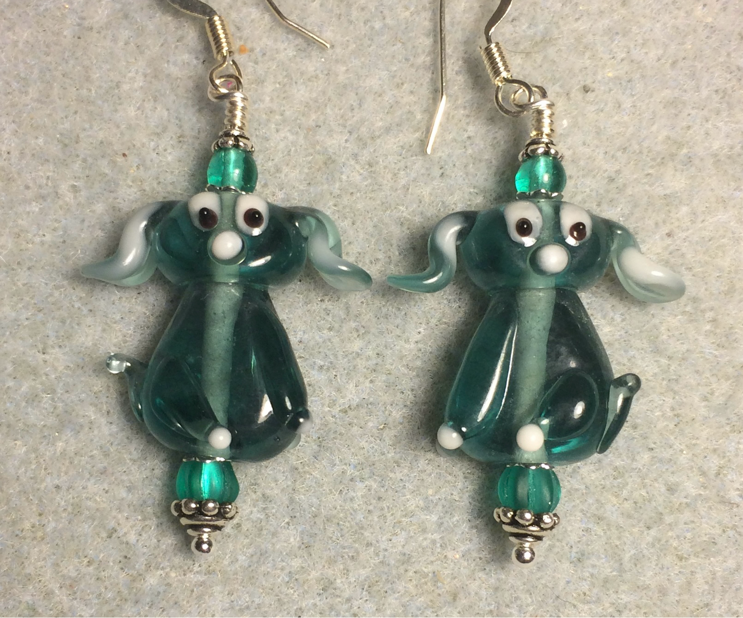 Translucent teal lamp work floppy eared puppy dog bead earrings adorned with teal Czech glass beads.