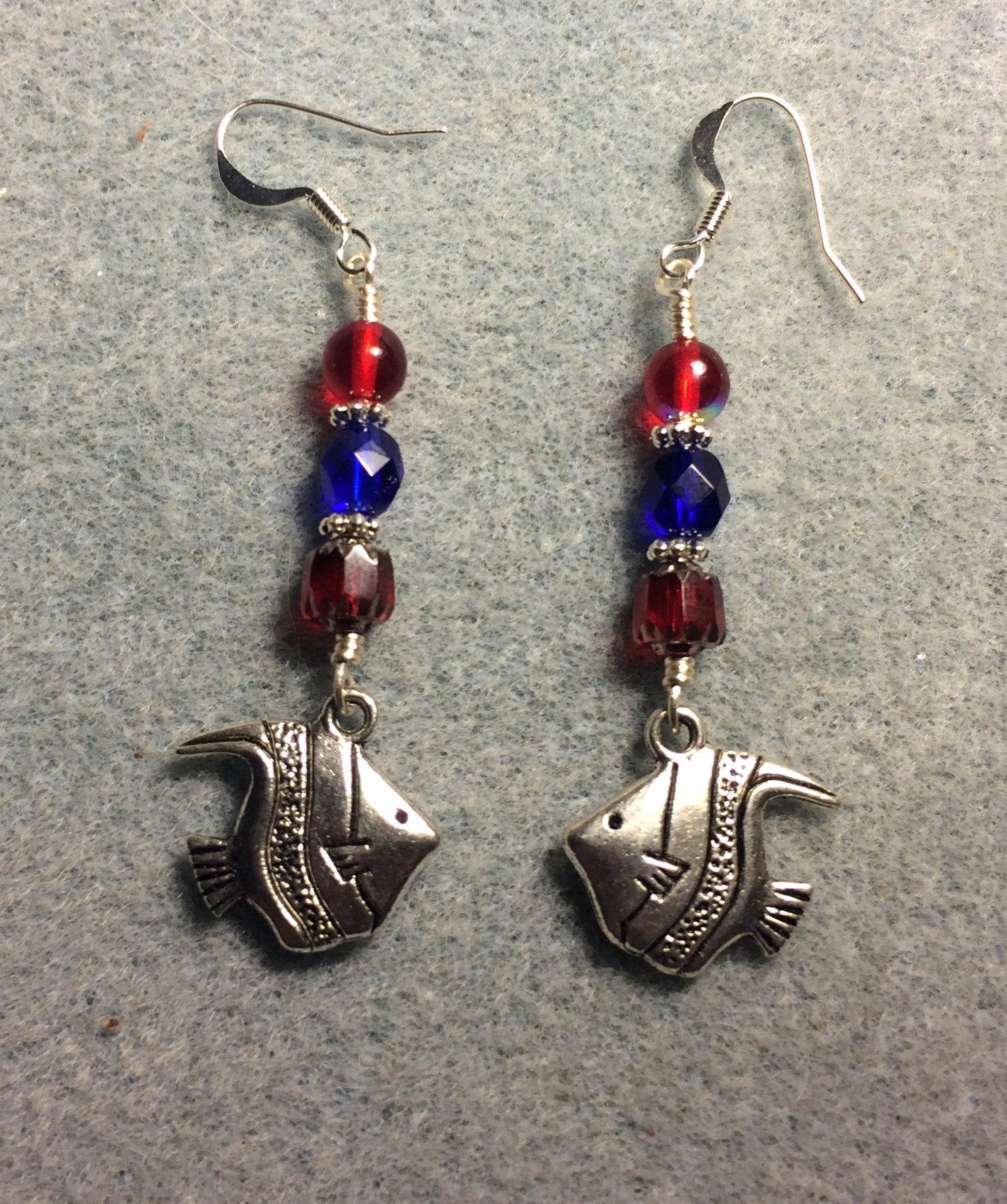 Silver angelfish charm earrings adorned with red and dark blue Czech glass beads