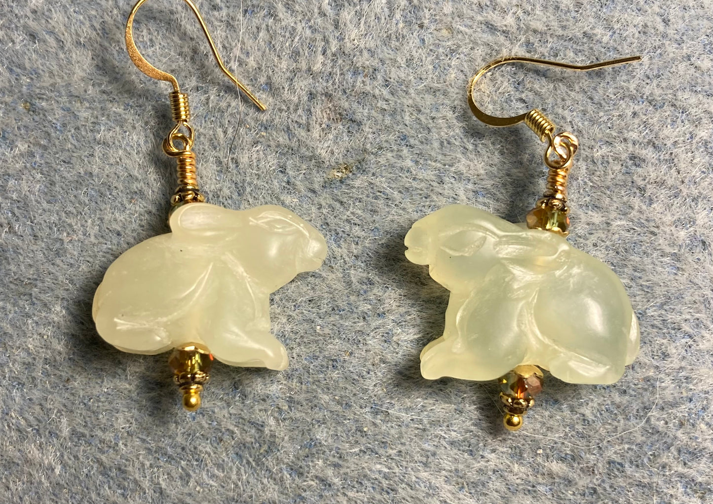 Light green new jade gemstone rabbit bead earrings adorned with sparkly olive green Chinese crystal beads.