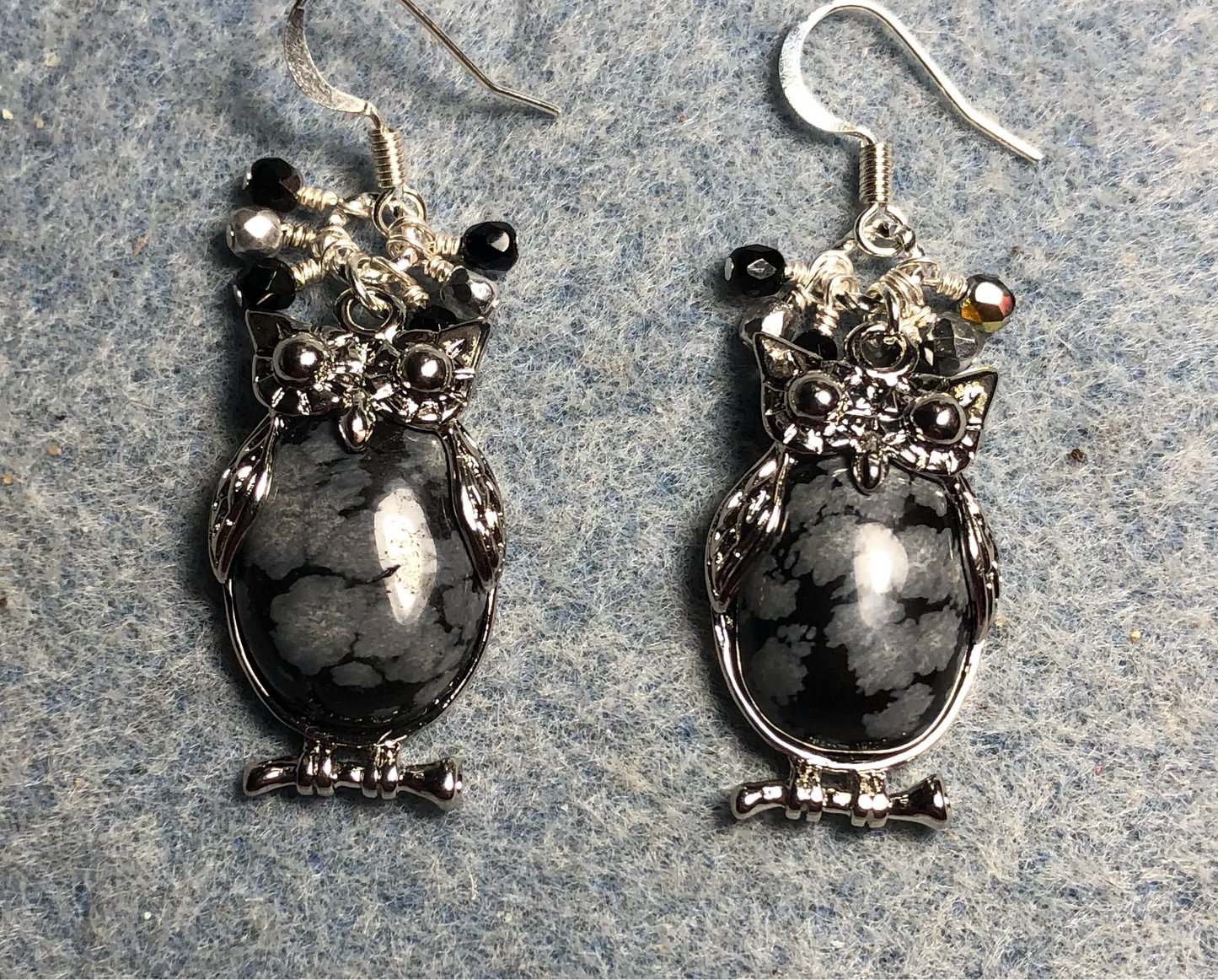 Large silver and snow jasper gemstone owl charm earrings adorned with small dangling black and silver Czech glass beads.
