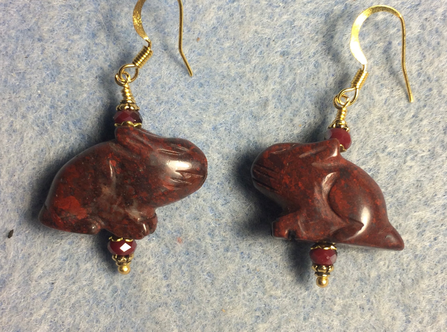Large red brecciated jasper gemstone rabbit bead earrings adorned with dark red Chinese crystal beads.