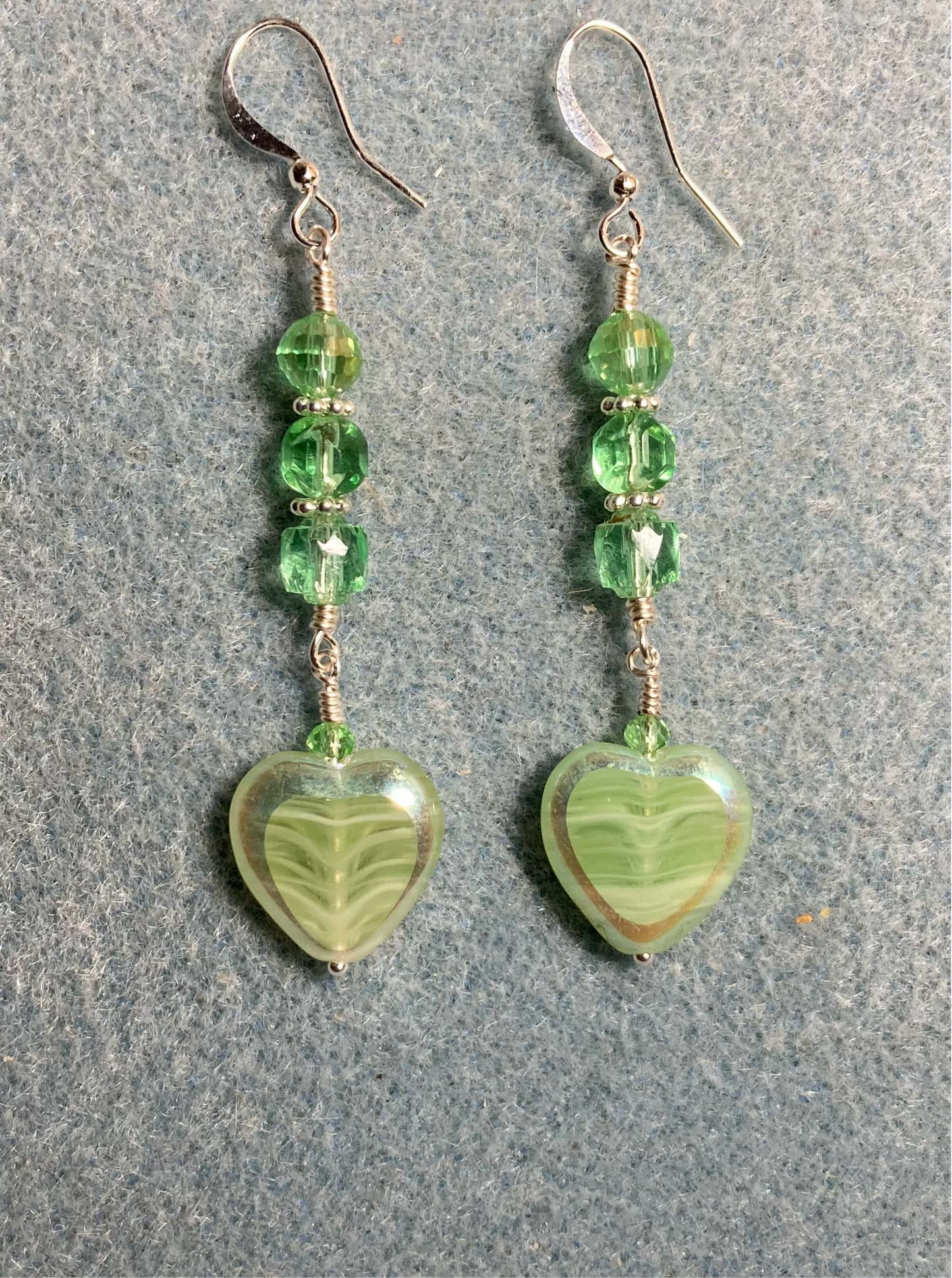 Light green Czech glass heart bead earrings adorned with light green Czech glass beads.