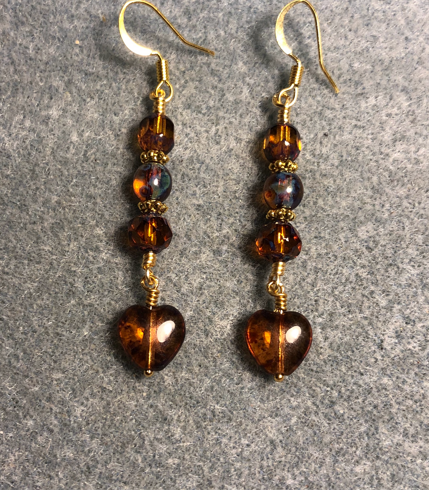Small translucent dark amber Czech glass heart bead earrings adorned with dark amber Czech glass beads.