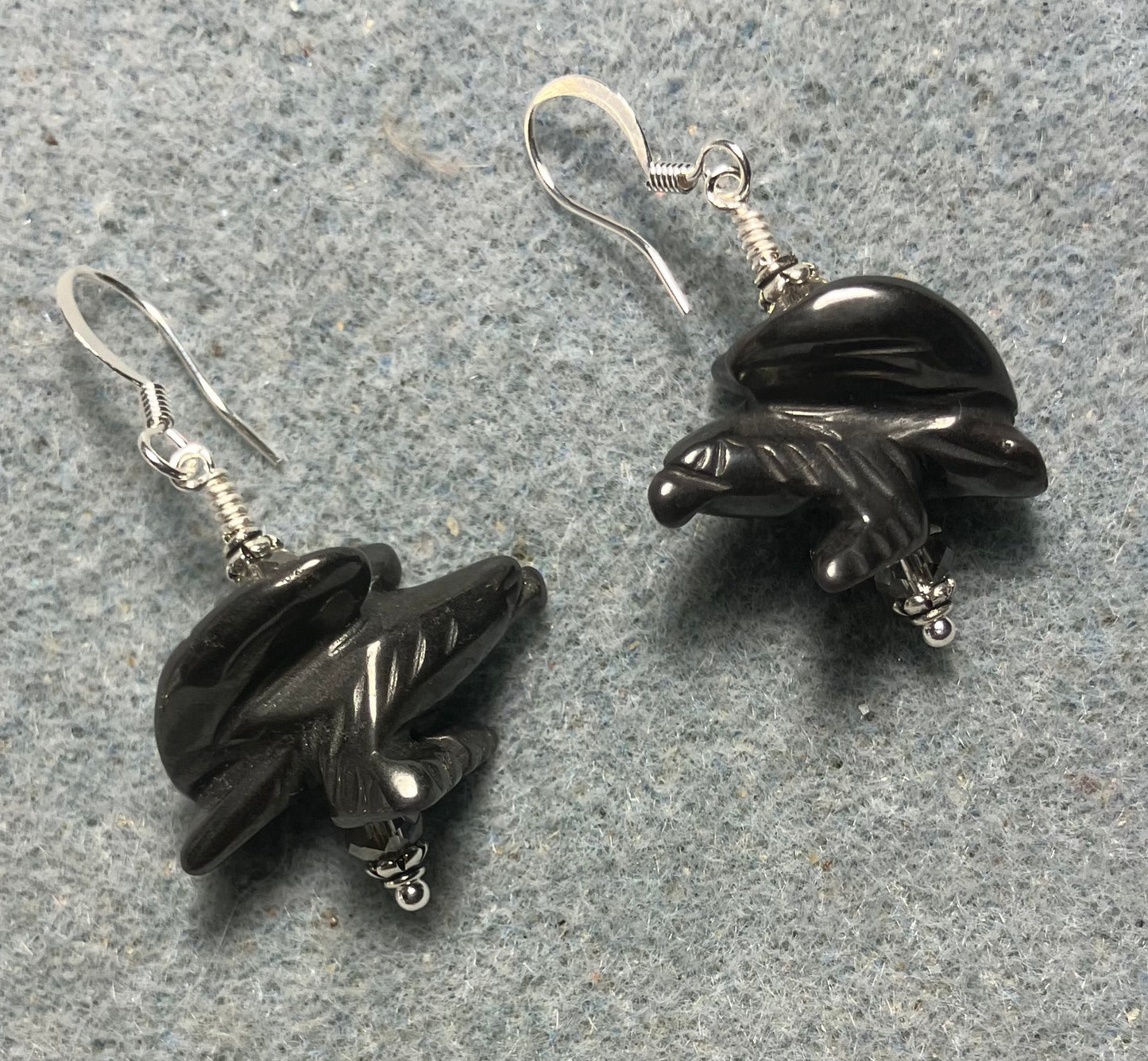 Large gray hematite gemstone flying eagle bead earrings adorned with gray Chinese crystal beads.