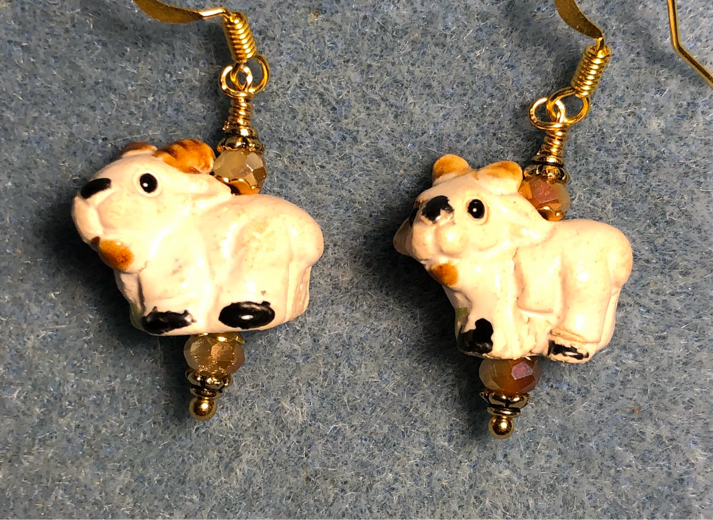 Small beige ceramic ram bead earrings adorned with beige Chinese crystal beads.