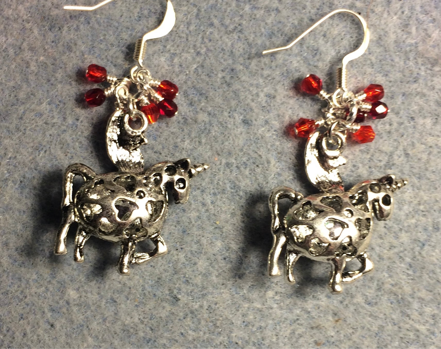 Silver and red rhinestone unicorn charm earrings adorned with small dangling silver and red Czech glass beads.