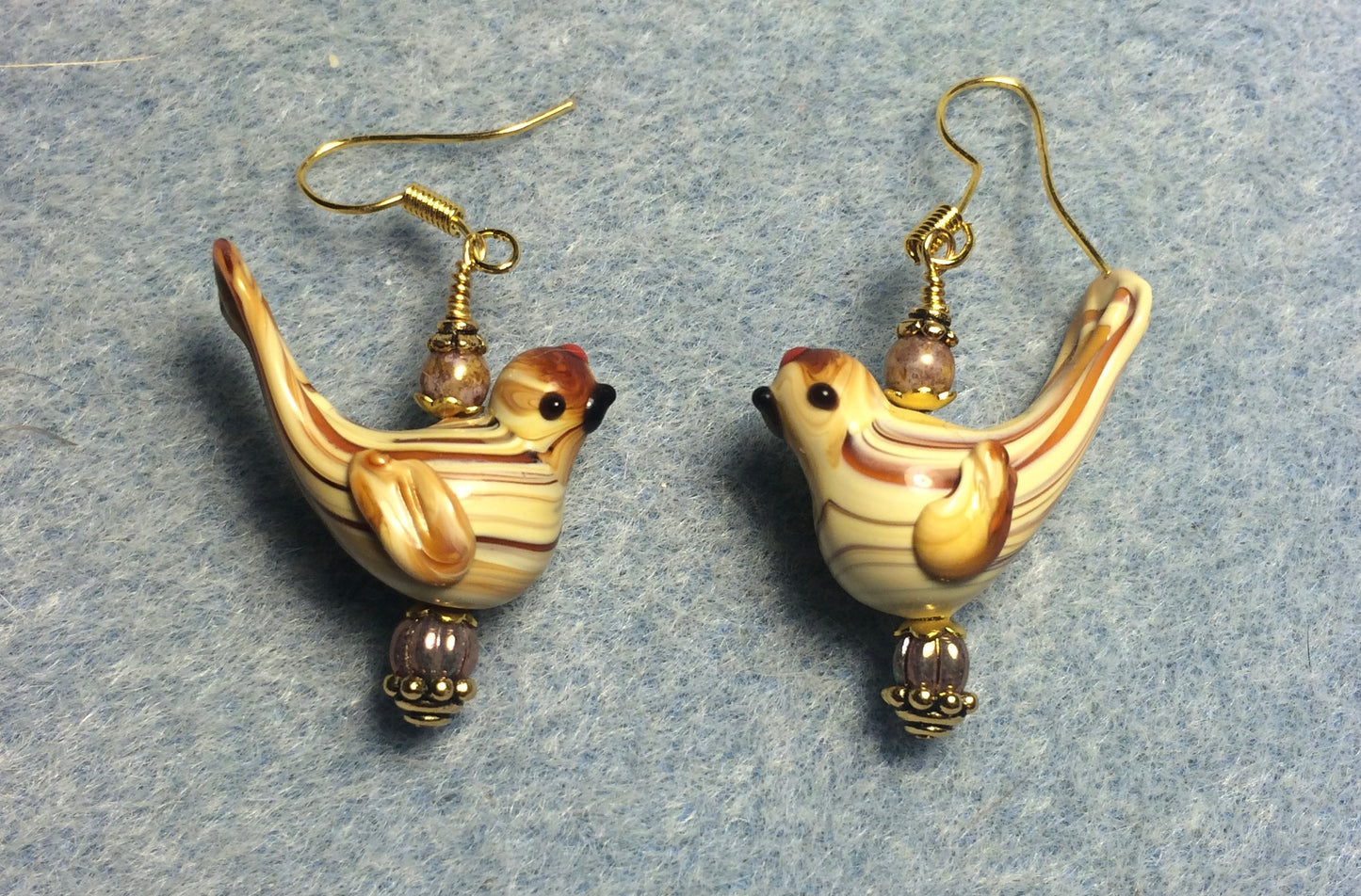 Tan lamp work striped songbird bead earrings adorned with tan Czech glass beads.