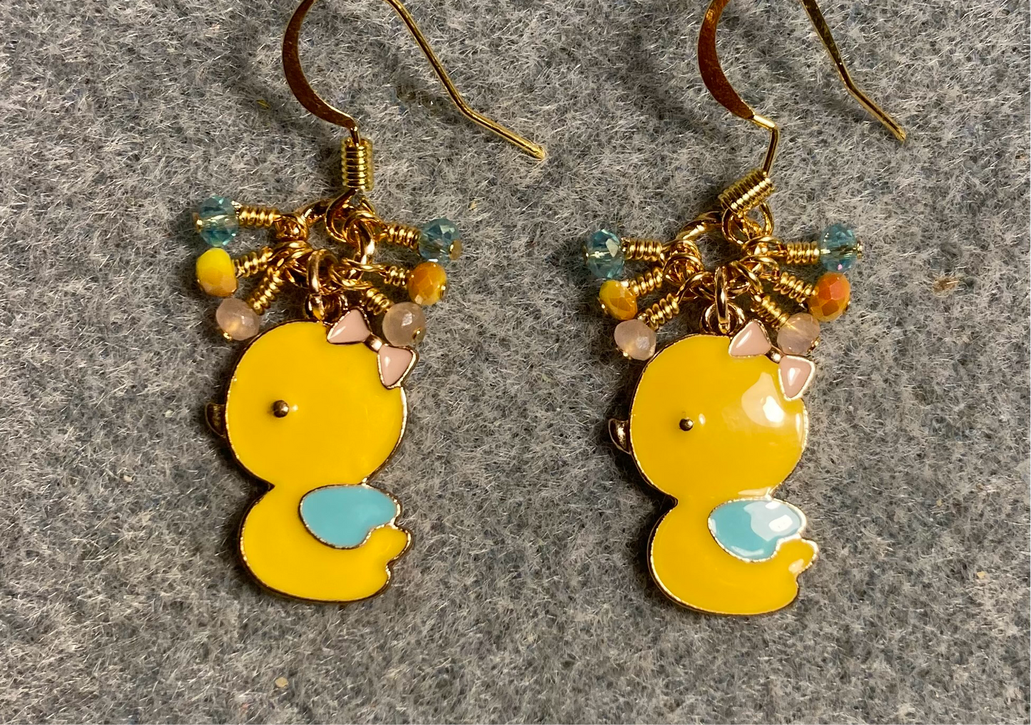 Yellow, turquoise, and peach enamel chick charm earrings adorned with tiny dangling yellow, turquoise, and peach Chinese crystal beads.