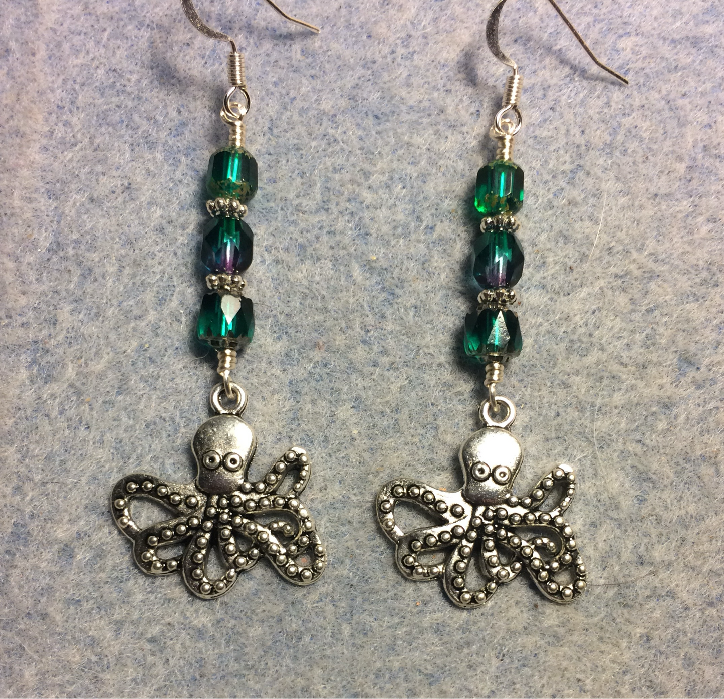 Silver octopus charm earrings adorned with teal and teal purple Czech glass beads
