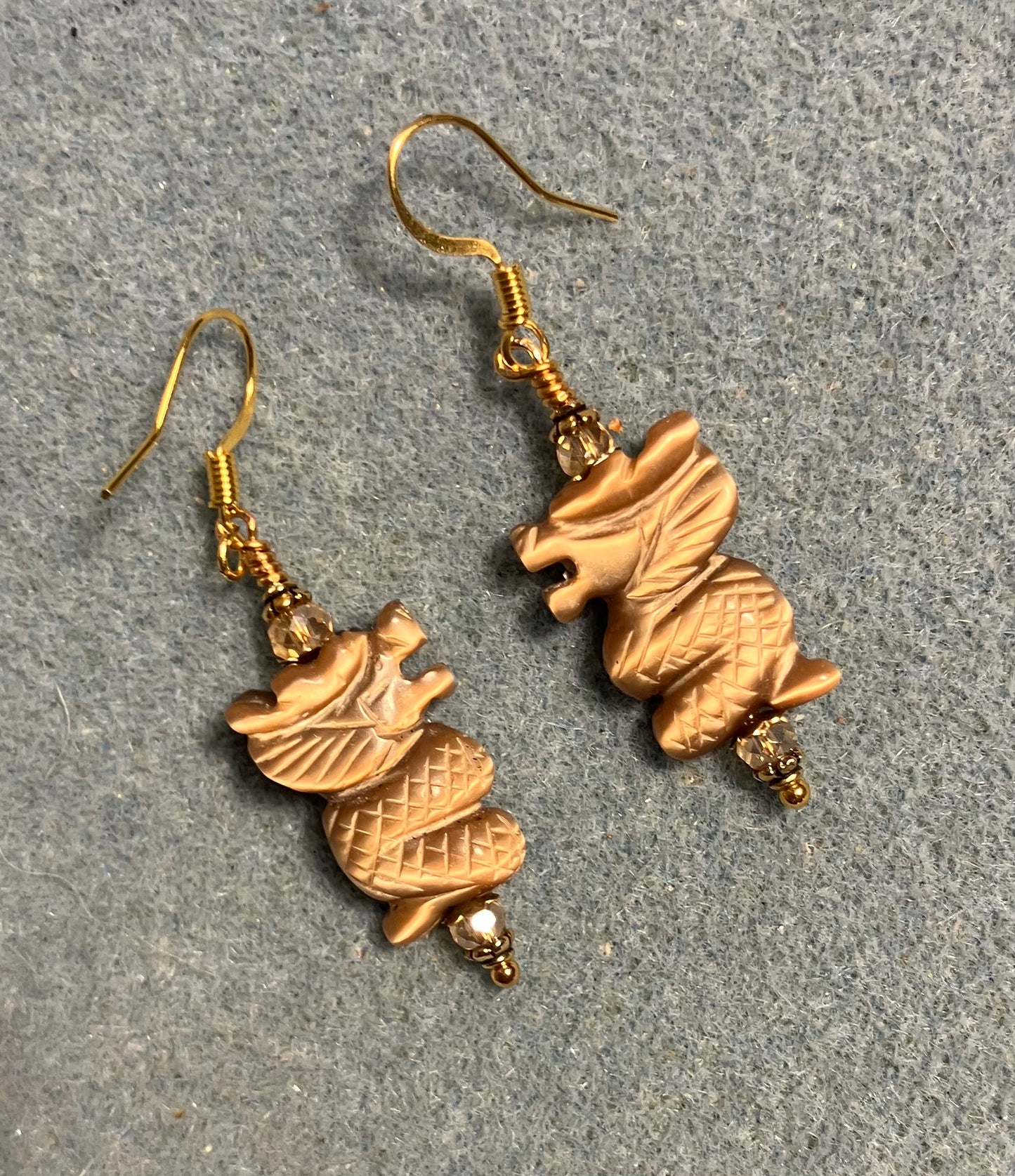 Tan fiber optic (cat’s eye) gemstone dragon bead earrings adorned with amber Chinese crystal beads.