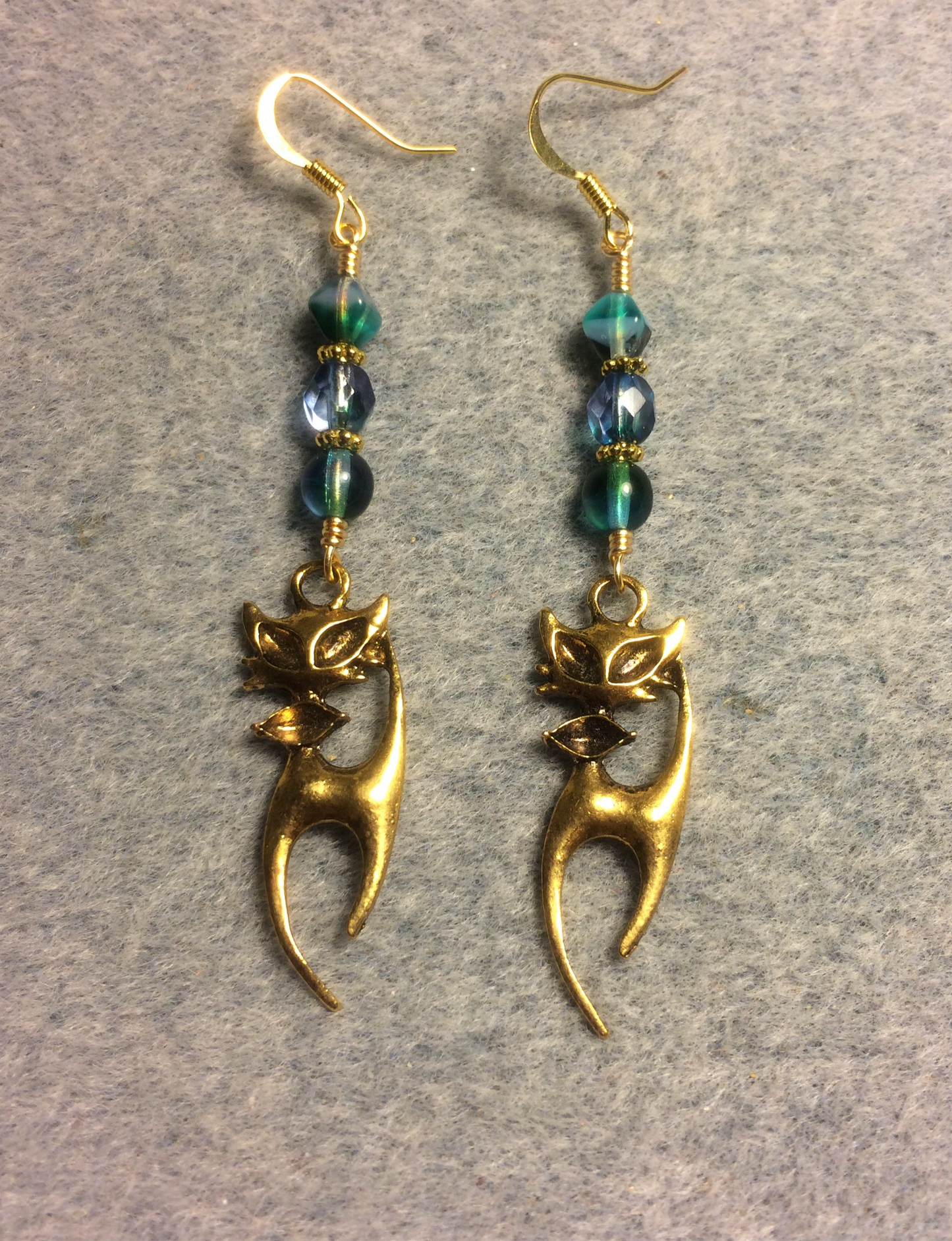 Long gold cat charm earrings adorned with blue green purple Czech glass beads
