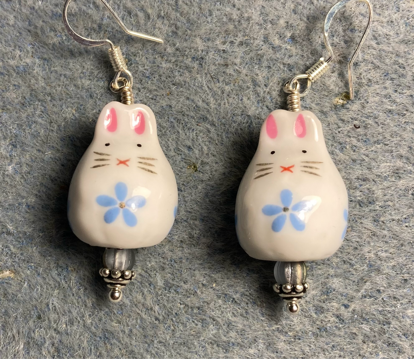 White, light blue, and pink ceramic bunny rabbit bead earrings adorned with light blue Czech glass beads.