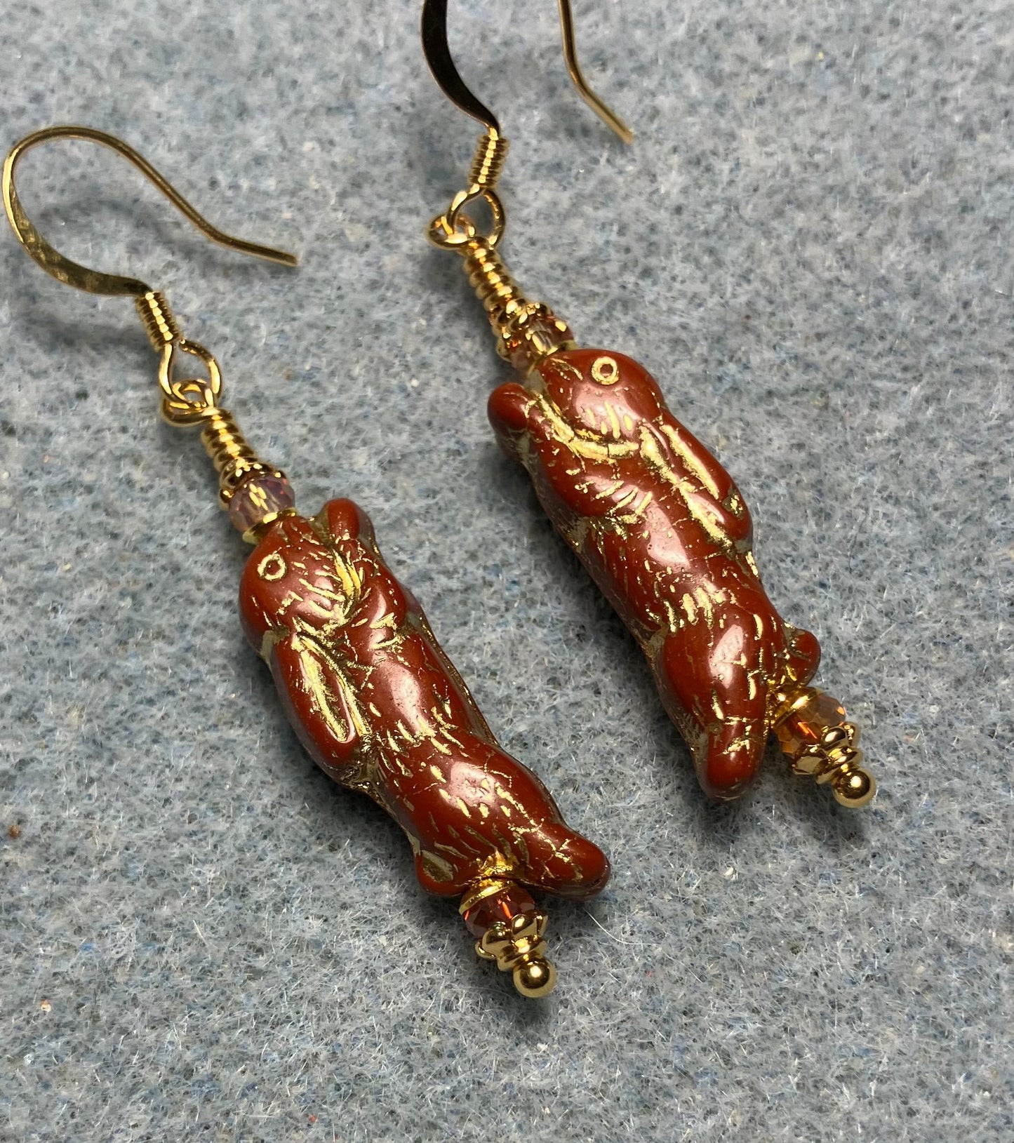 Small dark orange (with gold inlay) Czech glass bunny rabbit bead earrings adorned with orange Chinese crystal beads.