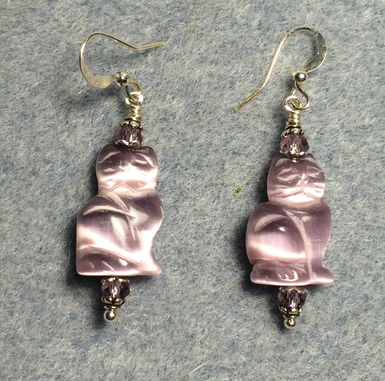 Violet fiber optic (cat’s eye) cat bead earrings adorned with violet Chinese crystal beads.