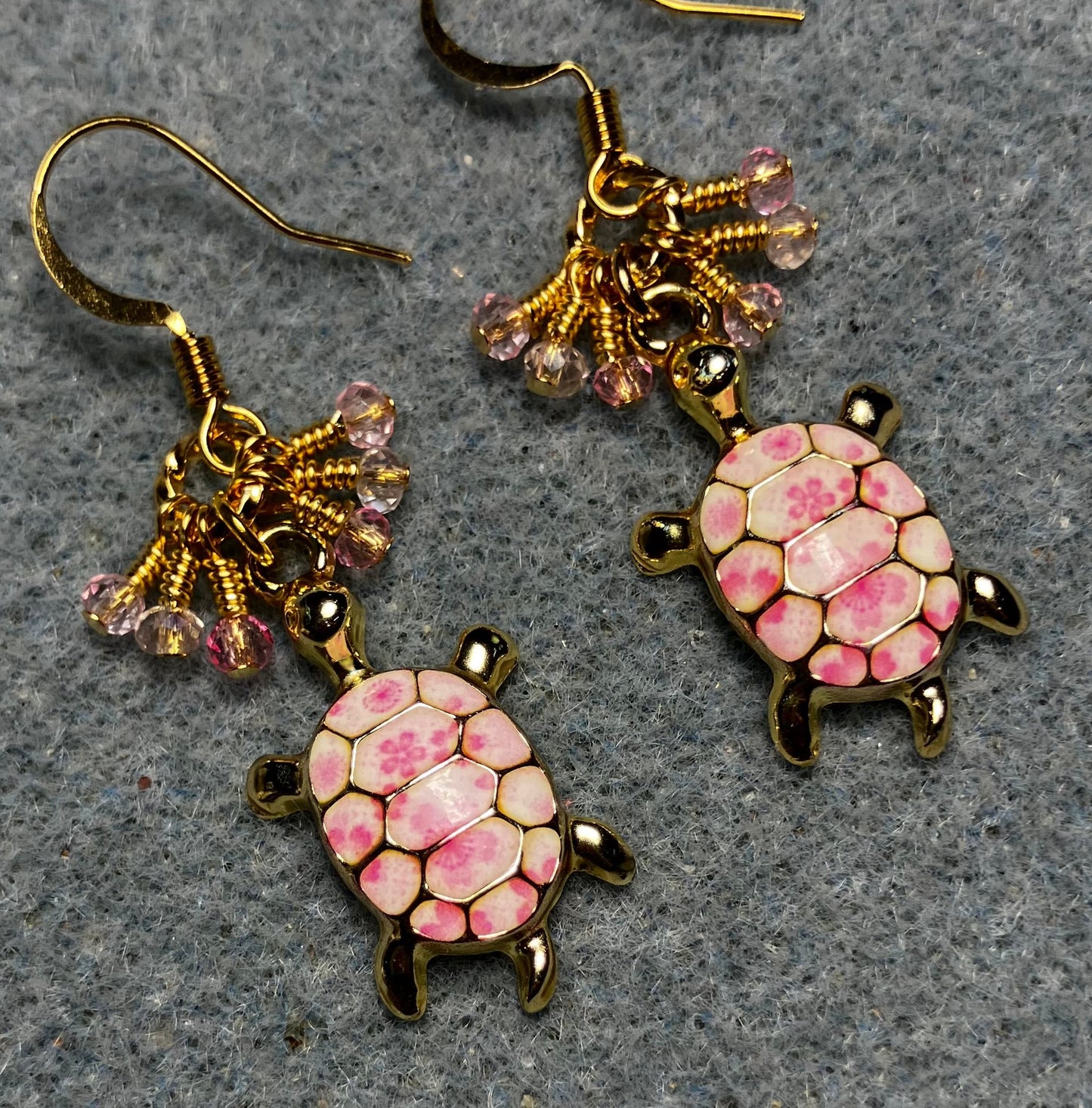 Pink and white enamel turtle charm earrings adorned with tiny dangling pink Chinese crystal beads.