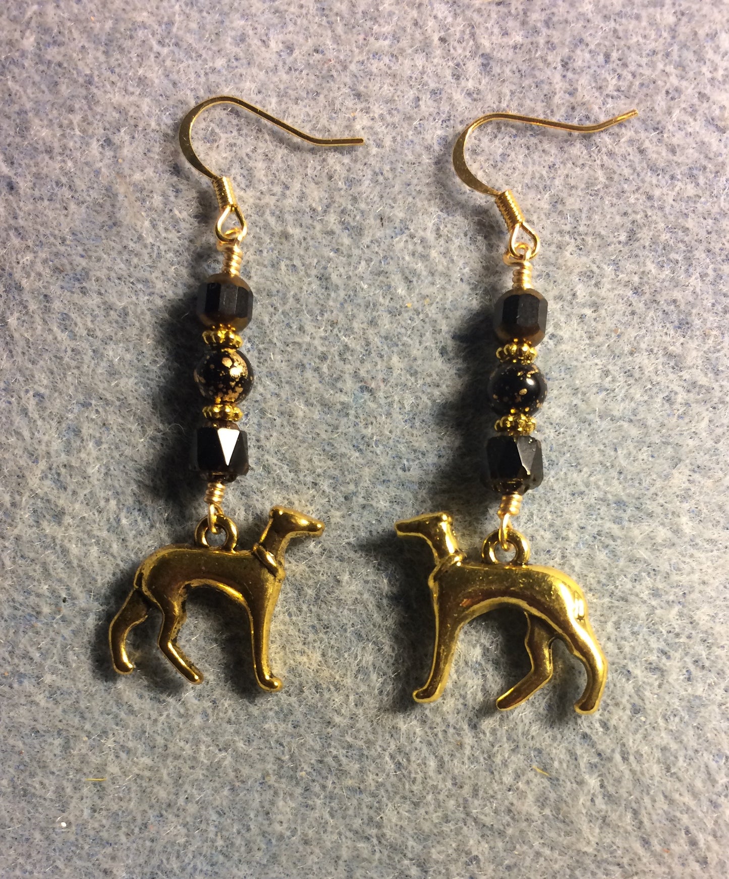 Gold greyhound charm earrings adorned with black Czech glass beads
