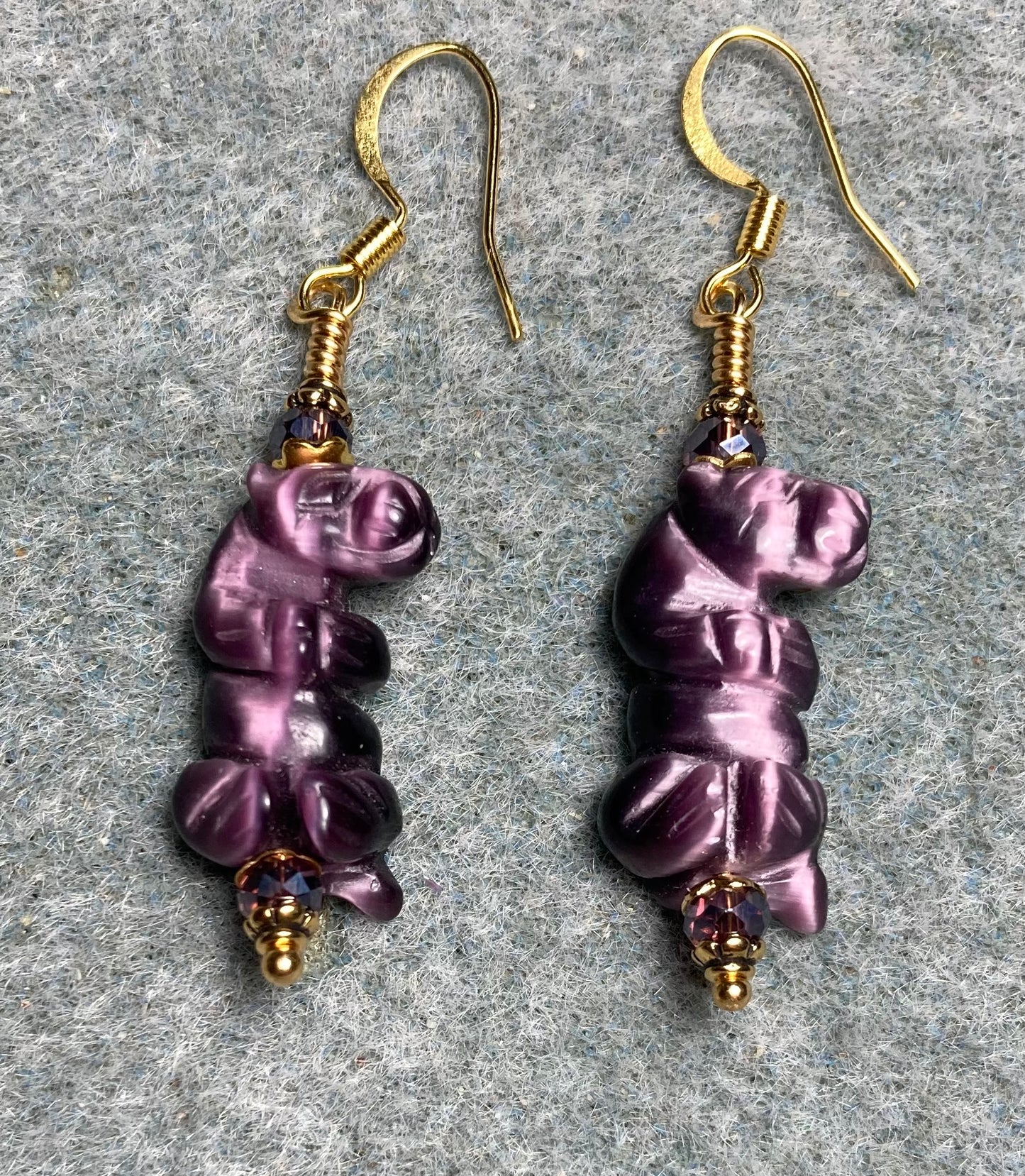Purple fiber optic (cat’s eye) standing otter bead earrings adorned with purple Chinese crystal beads.