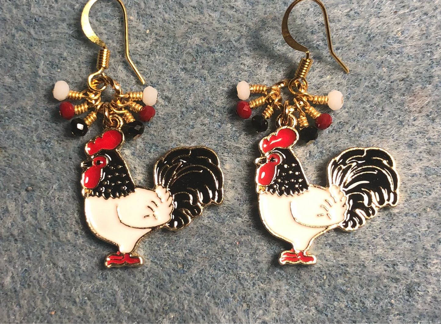 Red, white, and black enamel rooster charm earrings adorned with tiny dangling red, white, and black Chinese crystal beads.