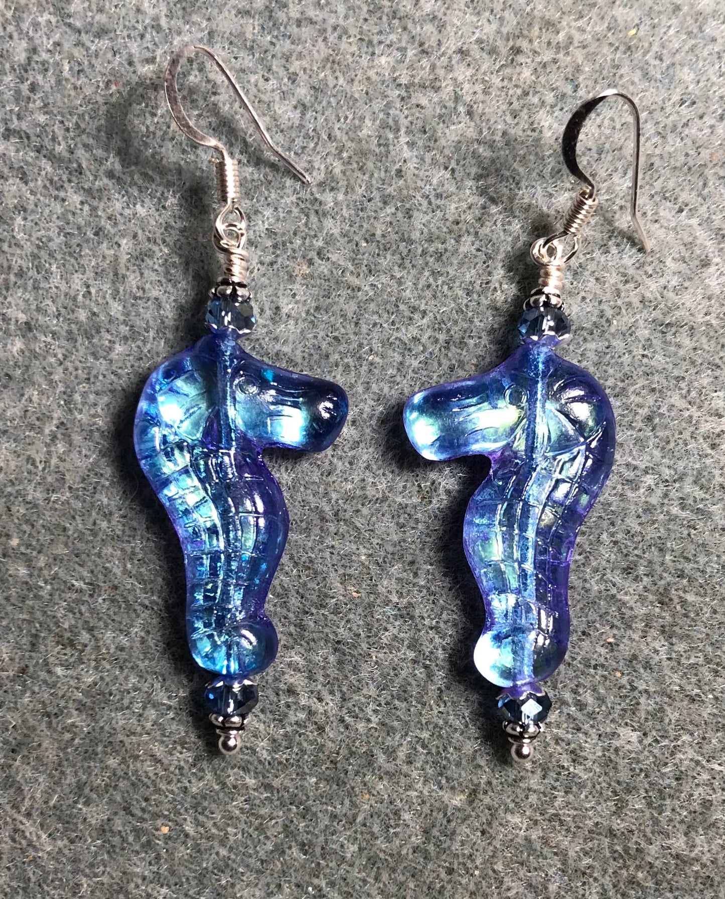 Shimmery light blue Czech glass seahorse bead earrings adorned with light blue Chinese crystal beads.