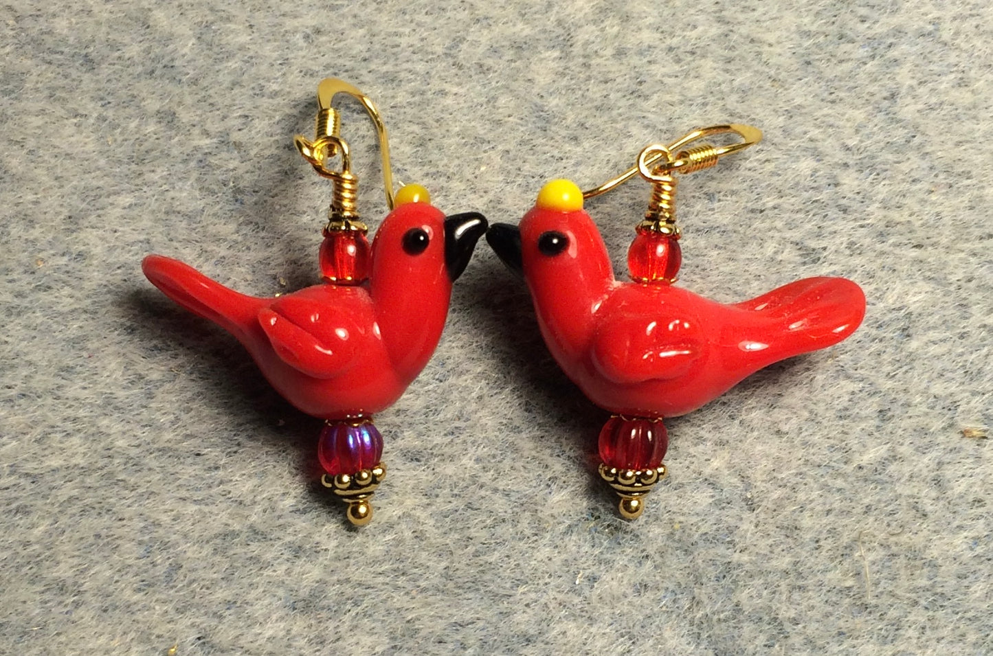 Opaque red lamp work songbird bead earrings adorned with red Czech glass beads.