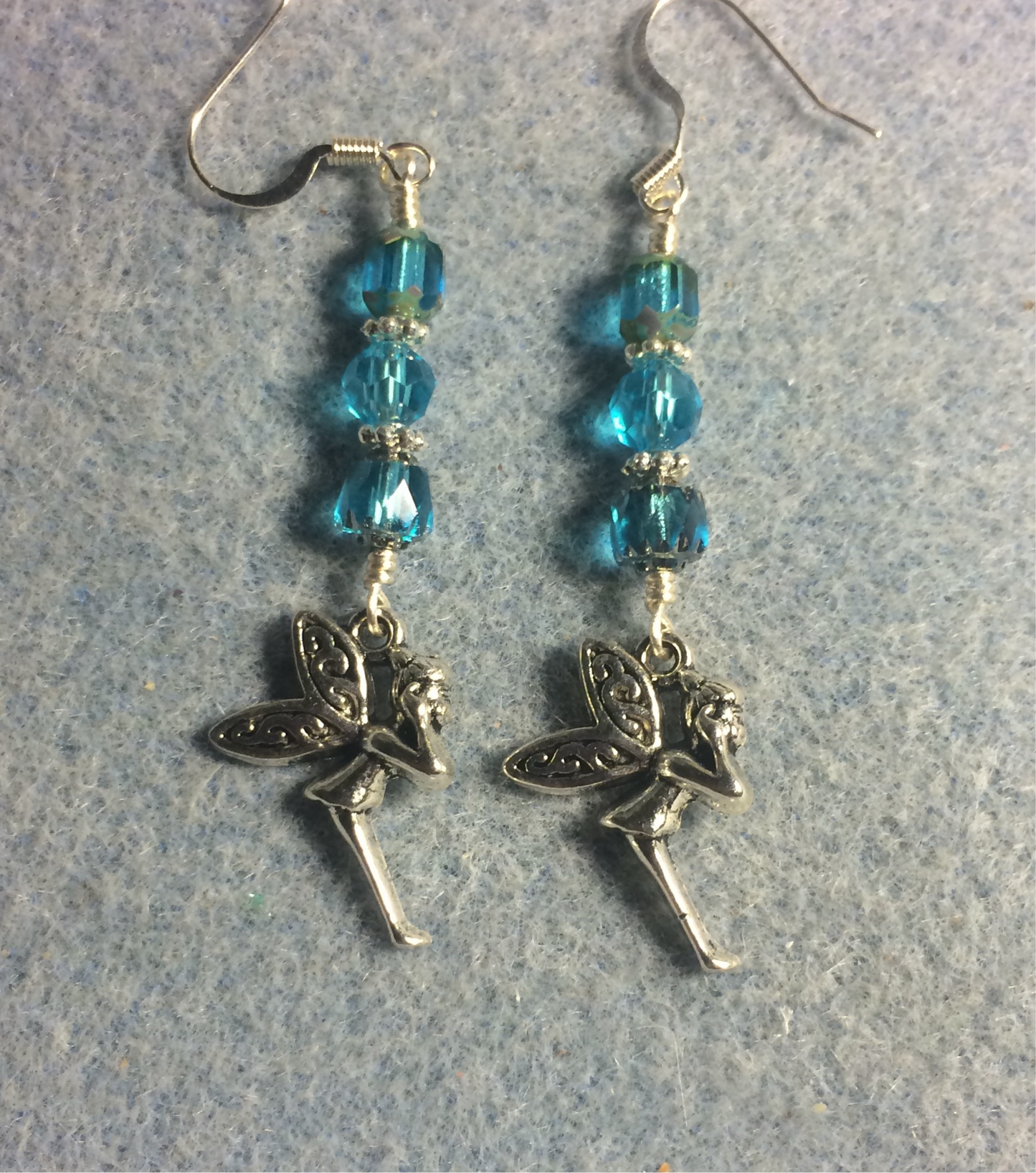 Silver fairy charm earrings adorned with turquoise Czech glass beads