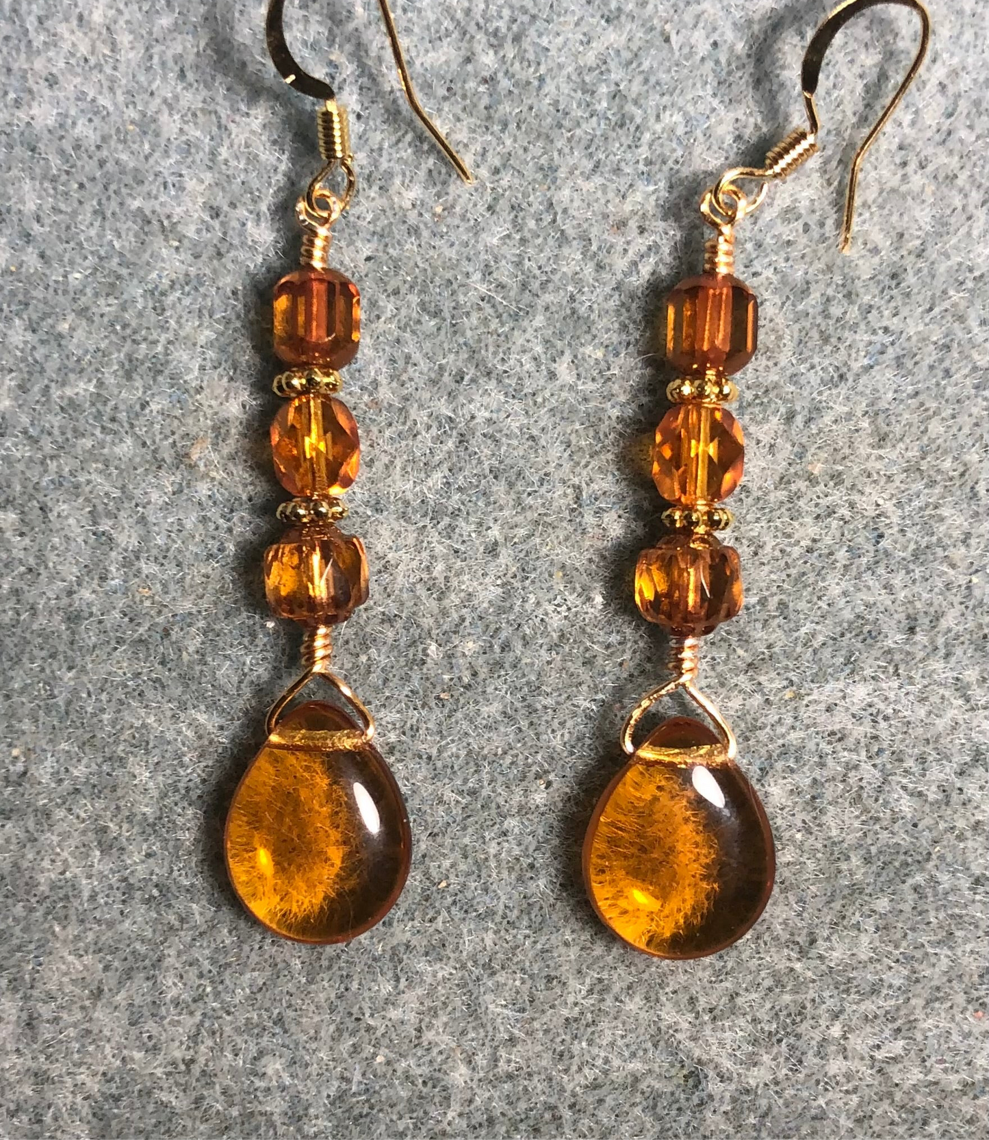 Amber Czech glass pear drop bead earrings adorned with light amber Czech glass beads.