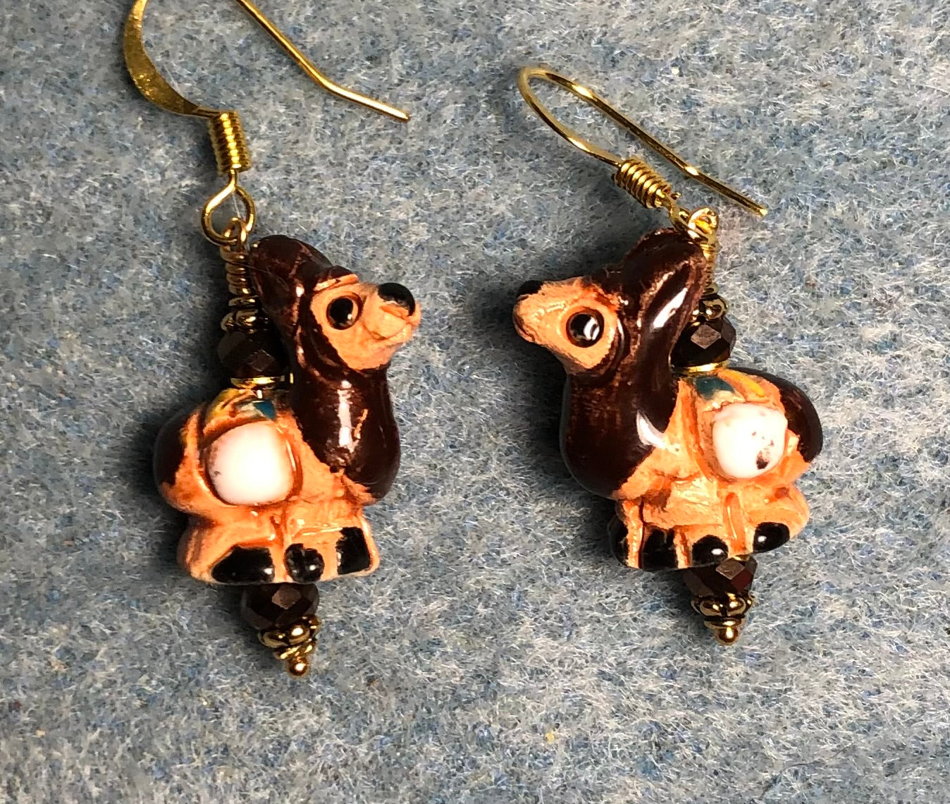Small brown, beige, and white ceramic llama bead earrings adorned with brown Chinese crystal beads.