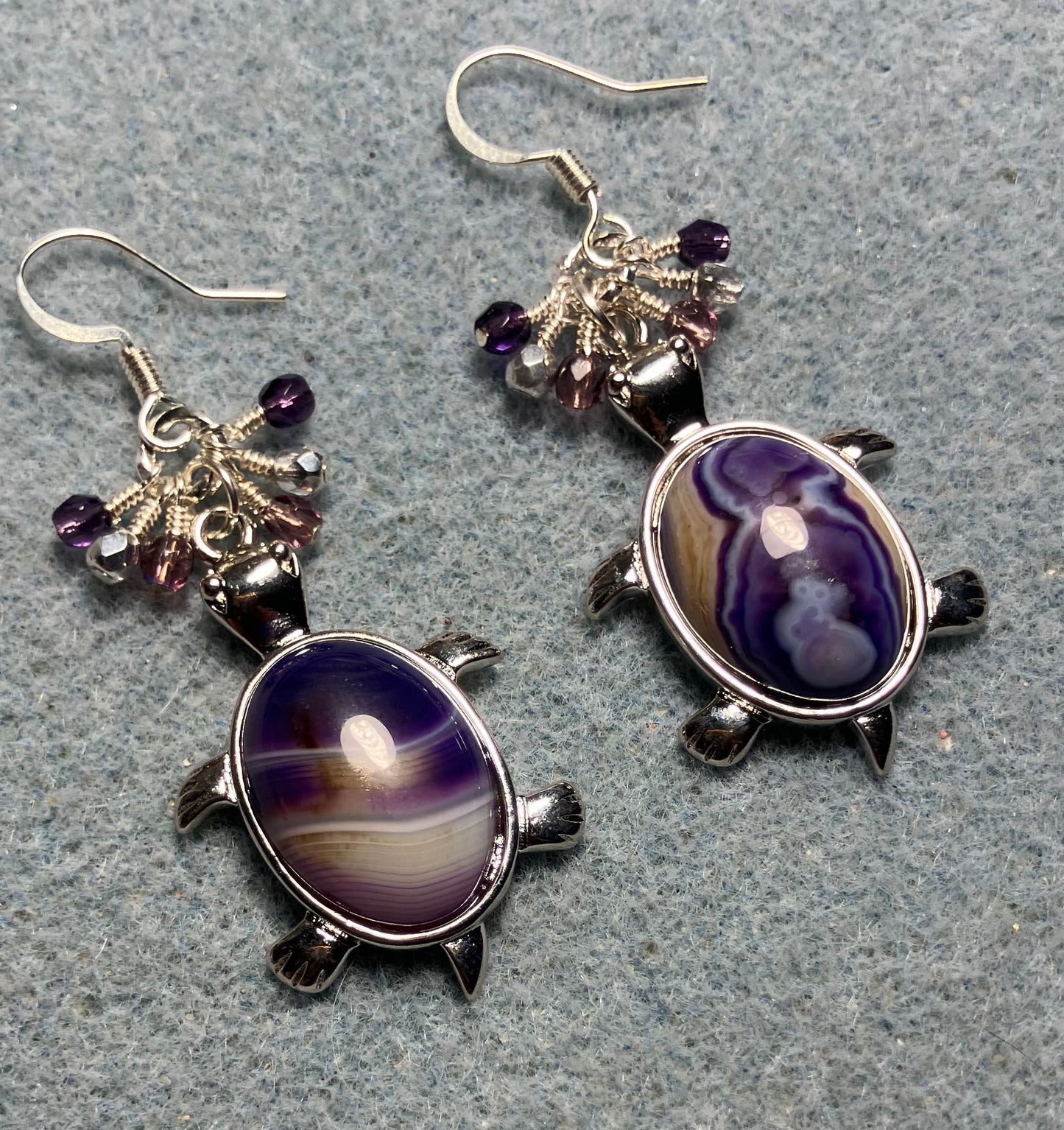 Large silver and purple agate gemstone turtle charm earrings adorned with small dangling purple and silver Czech glass beads.