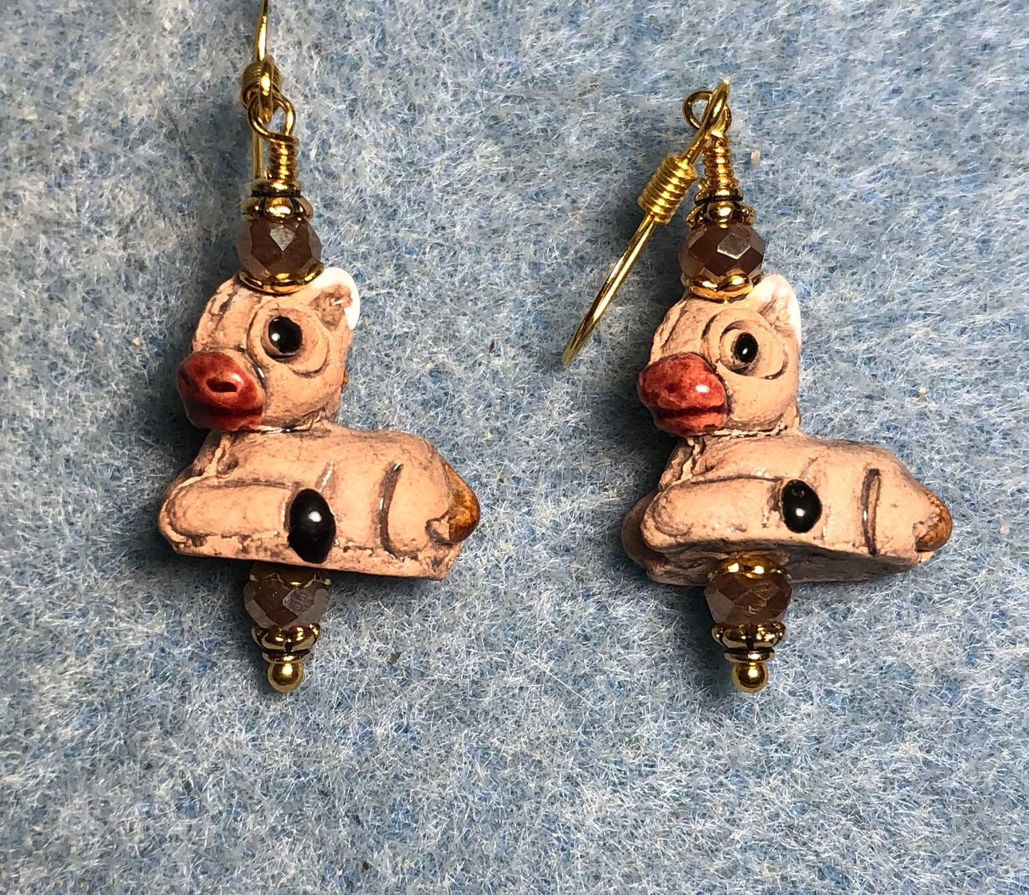 Small brown and red ceramic sitting donkey bead earrings adorned with brown Chinese crystal beads.