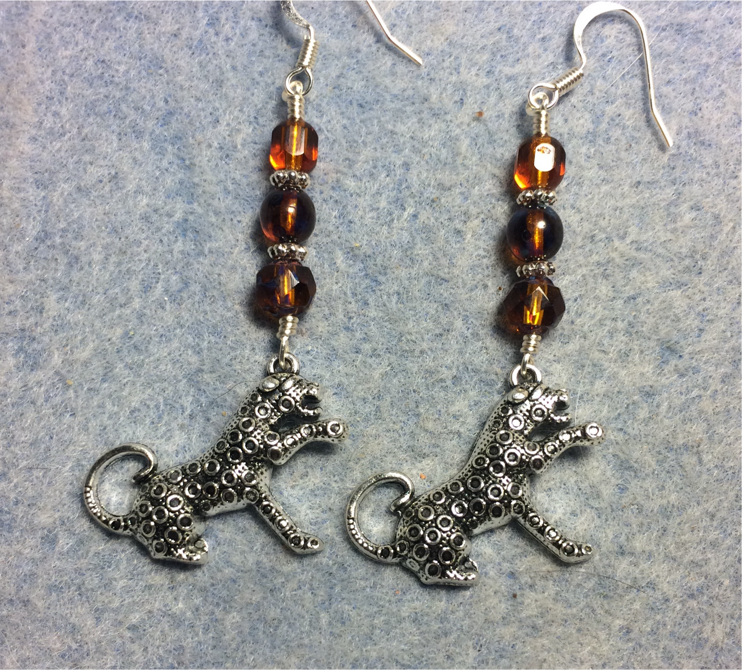 Silver leopard charm earrings adorned with topaz Czech glass beads