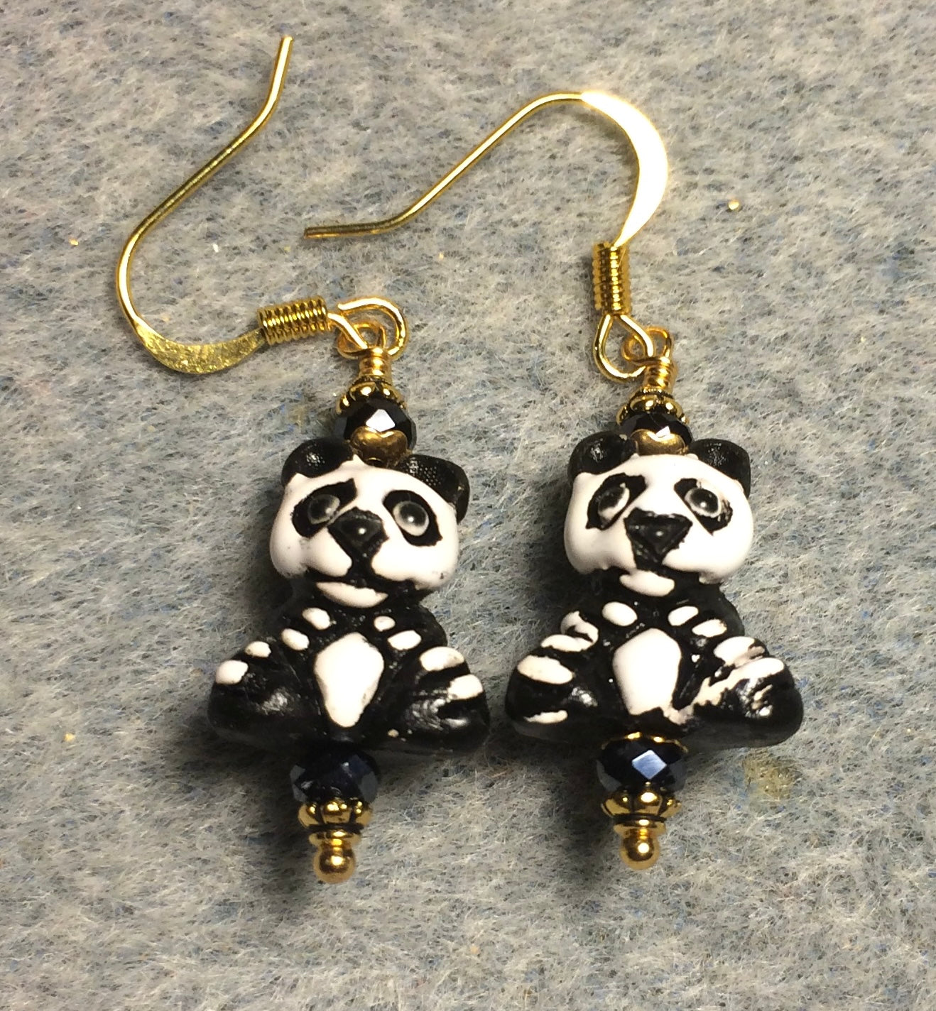 Small black and white ceramic panda bear bead earrings adorned with black Chinese crystal beads.