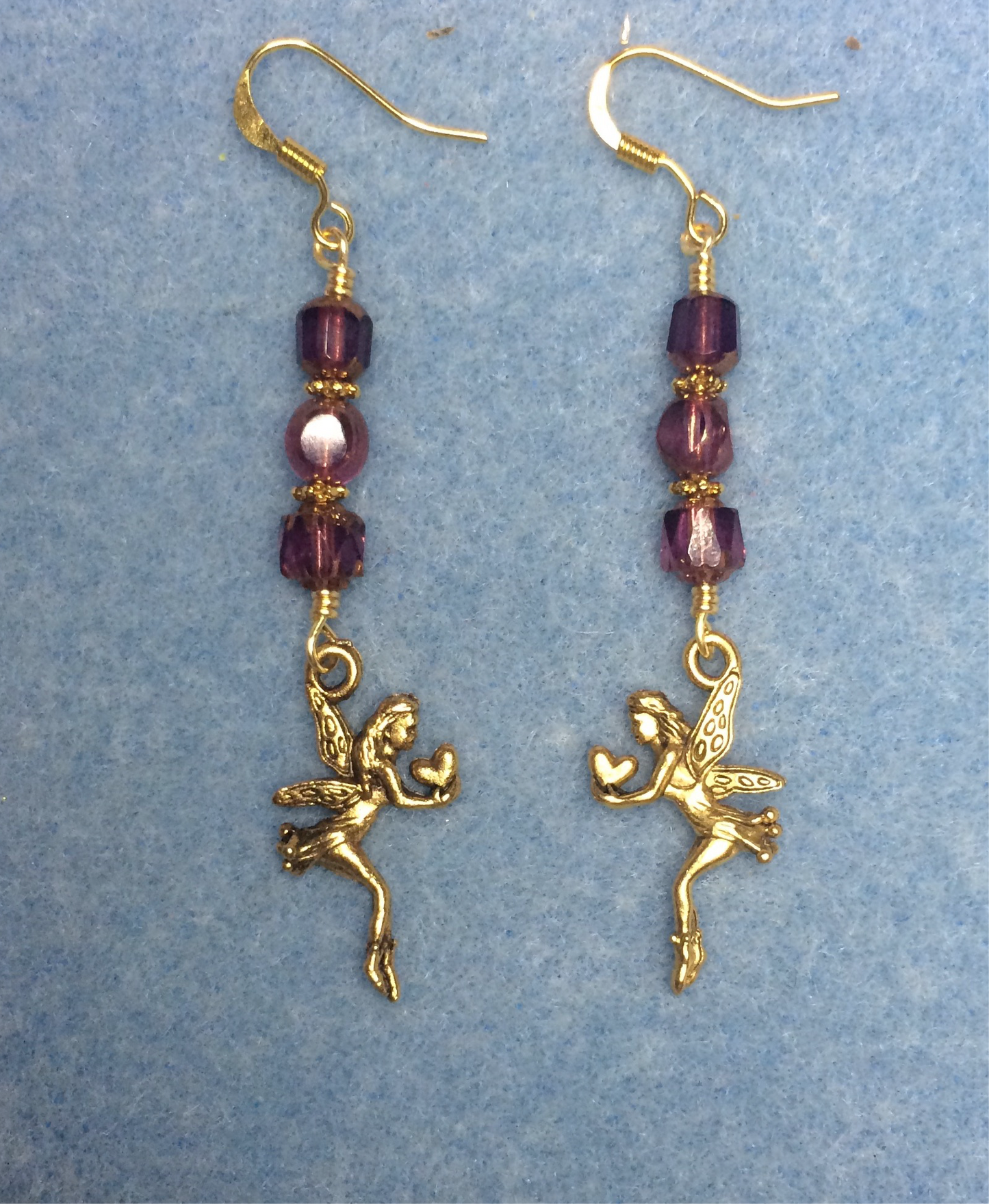 Gold fairy charm earrings adorned with purple Czech glass beads