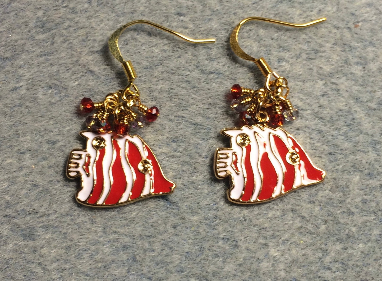 Red and white enamel striped angelfish charm earrings adorned with tiny dangling red and amber Chinese crystal beads.