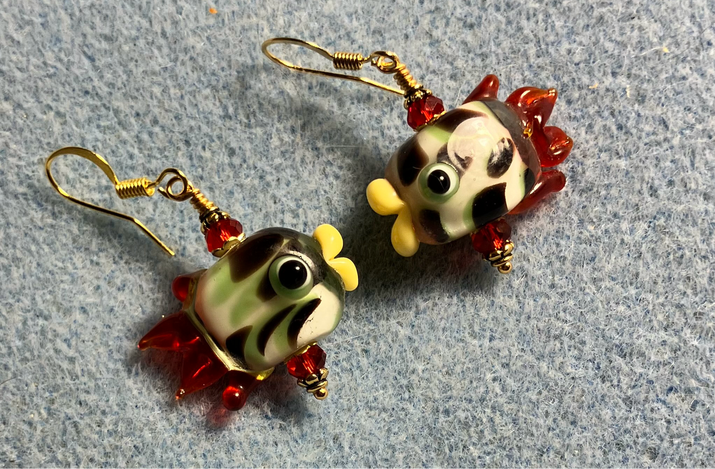 White and red lamp work spotted fish bead earrings adorned with red Chinese crystal beads.