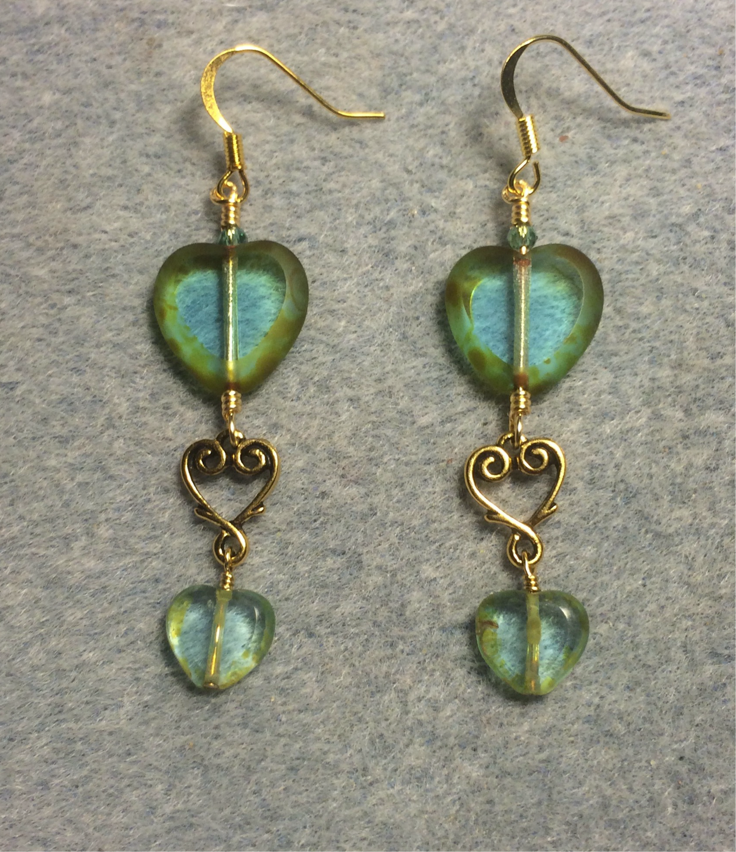 Large and small matching turquoise green Czech glass heart bead earrings joined by gold Tierracast heart connectors.