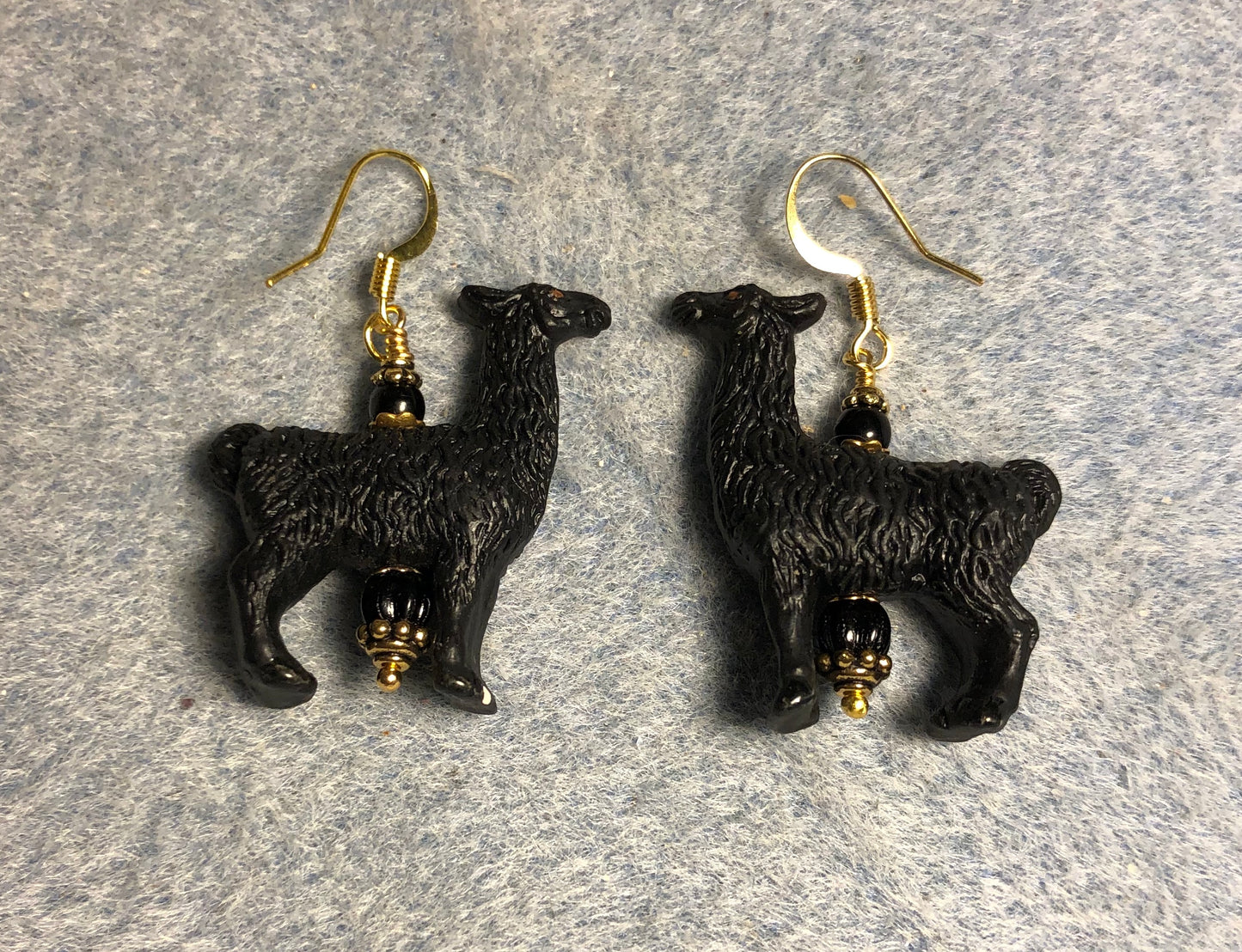 Large black ceramic llama bead earrings adorned with black Czech glass beads.