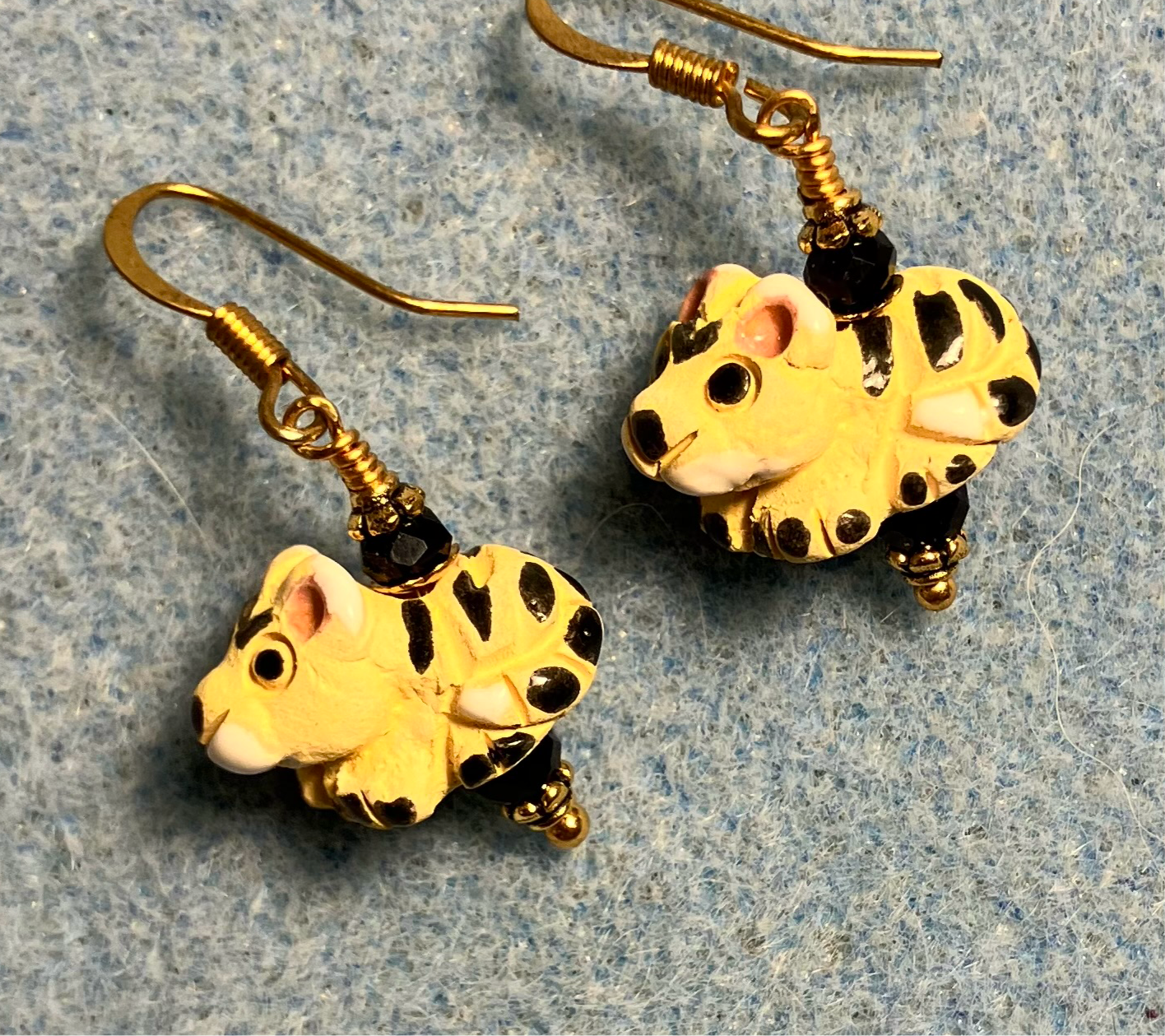 Small yellow and black ceramic exotic cat bead earrings adorned with black Chinese crystal beads.
