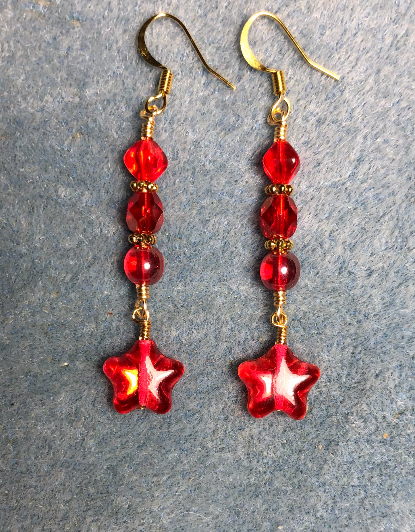 Small metallic red Czech glass star bead earrings adorned with bright red Czech glass beads.
