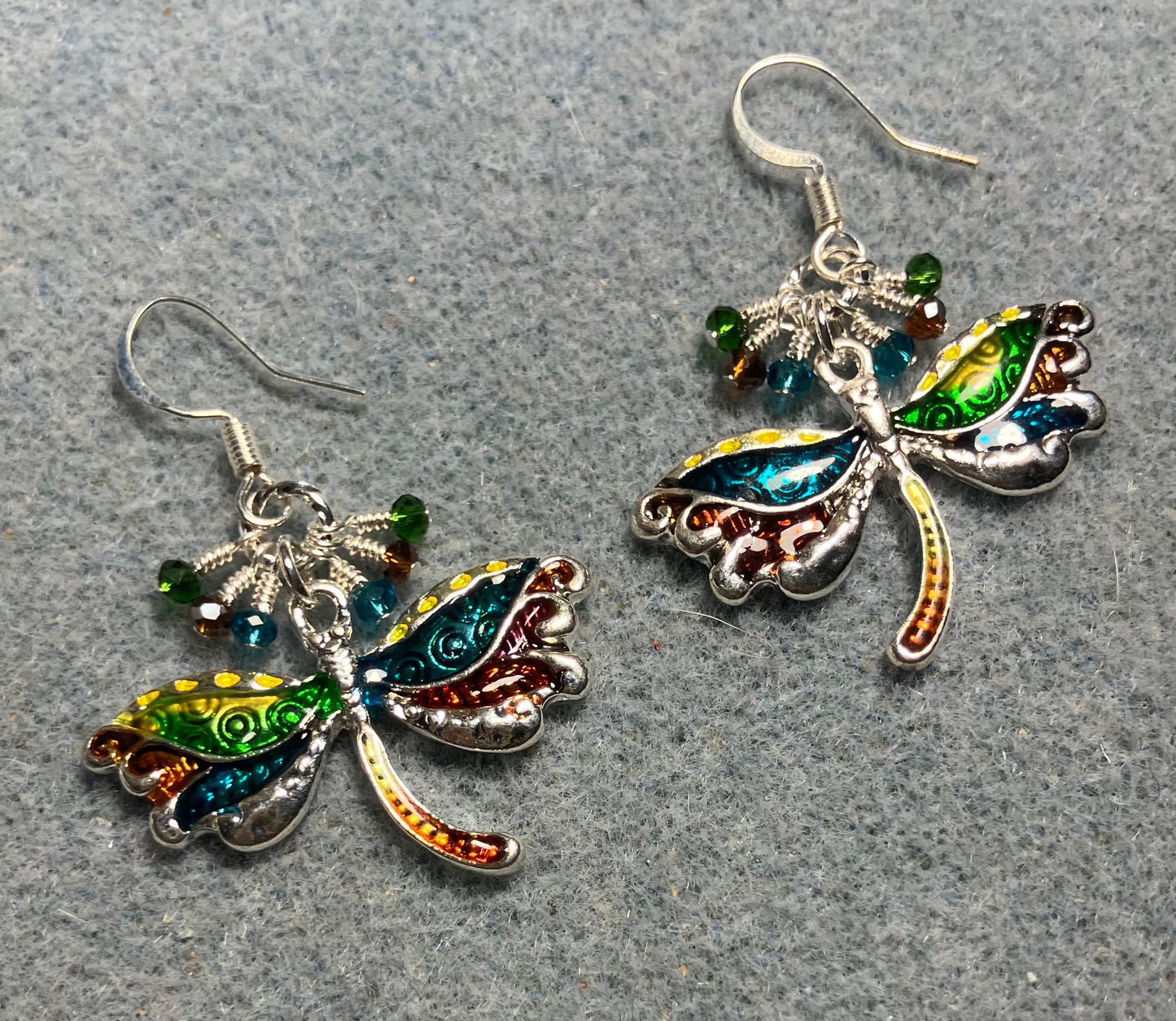 Turquoise, brown,and green dragonfly charm earrings adorned with tiny dangling turquoise, brown, and green Chinese crystal beads.