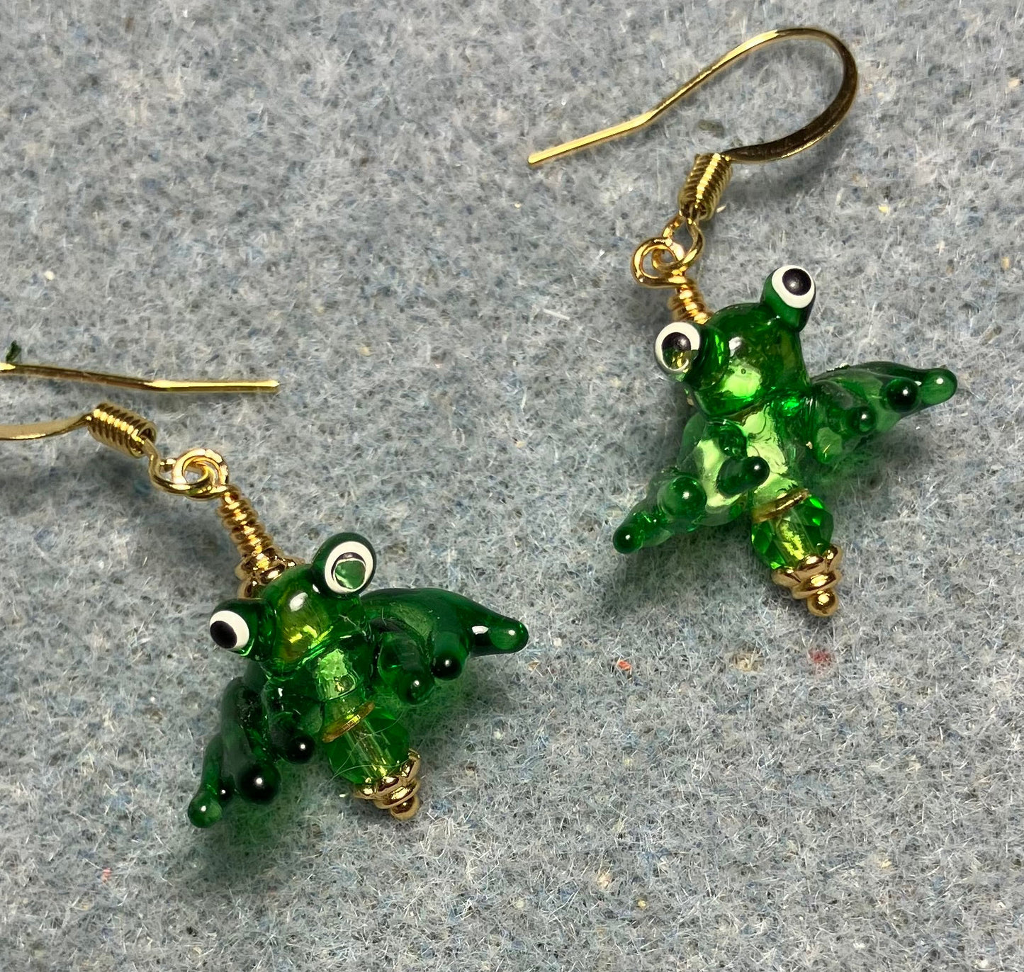 Tiny shiny kelly green lamp work frog bead earrings adorned with tiny kelly green Chinese crystal beads.