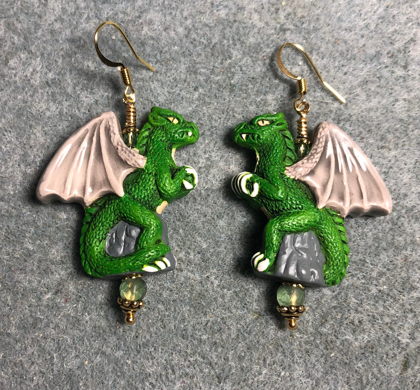 Large green dragon bead earrings adorned with green Czech glass beads.