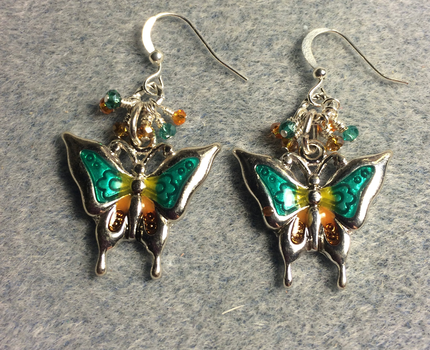 Teal, orange, and silver enamel and rhinestone butterfly charm earrings adorned with tiny dangling teal, orange, and clear Chinese crystal beads.