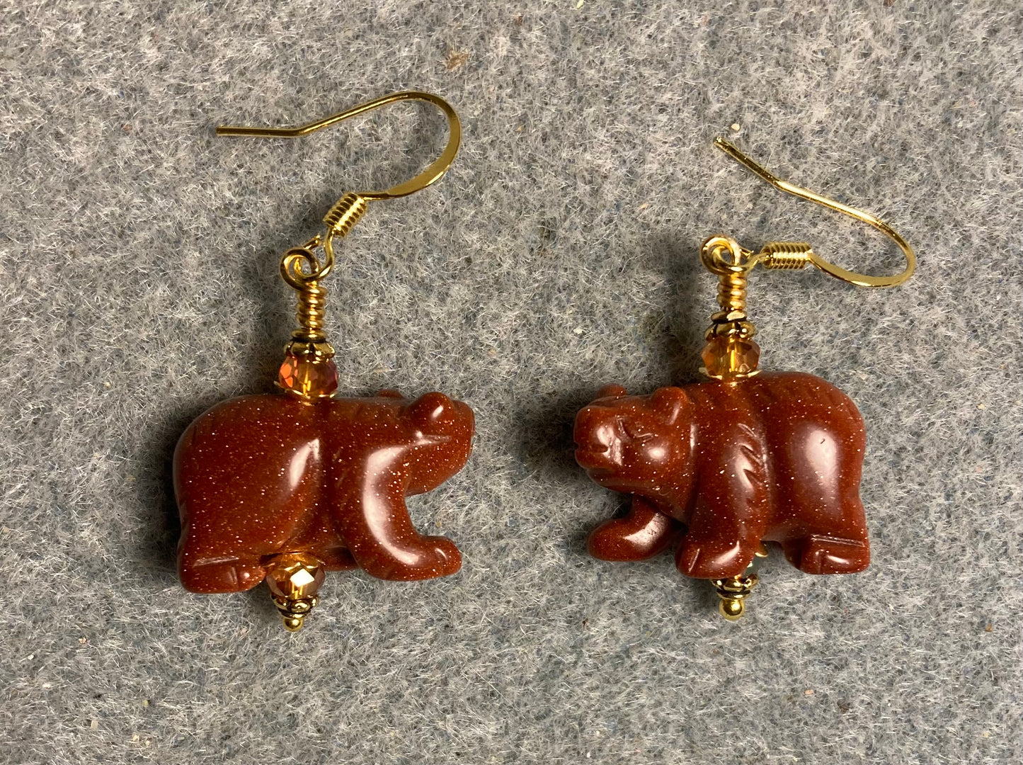 Large goldstone gemstone bear bead earrings adorned with orange Chinese crystal beads.