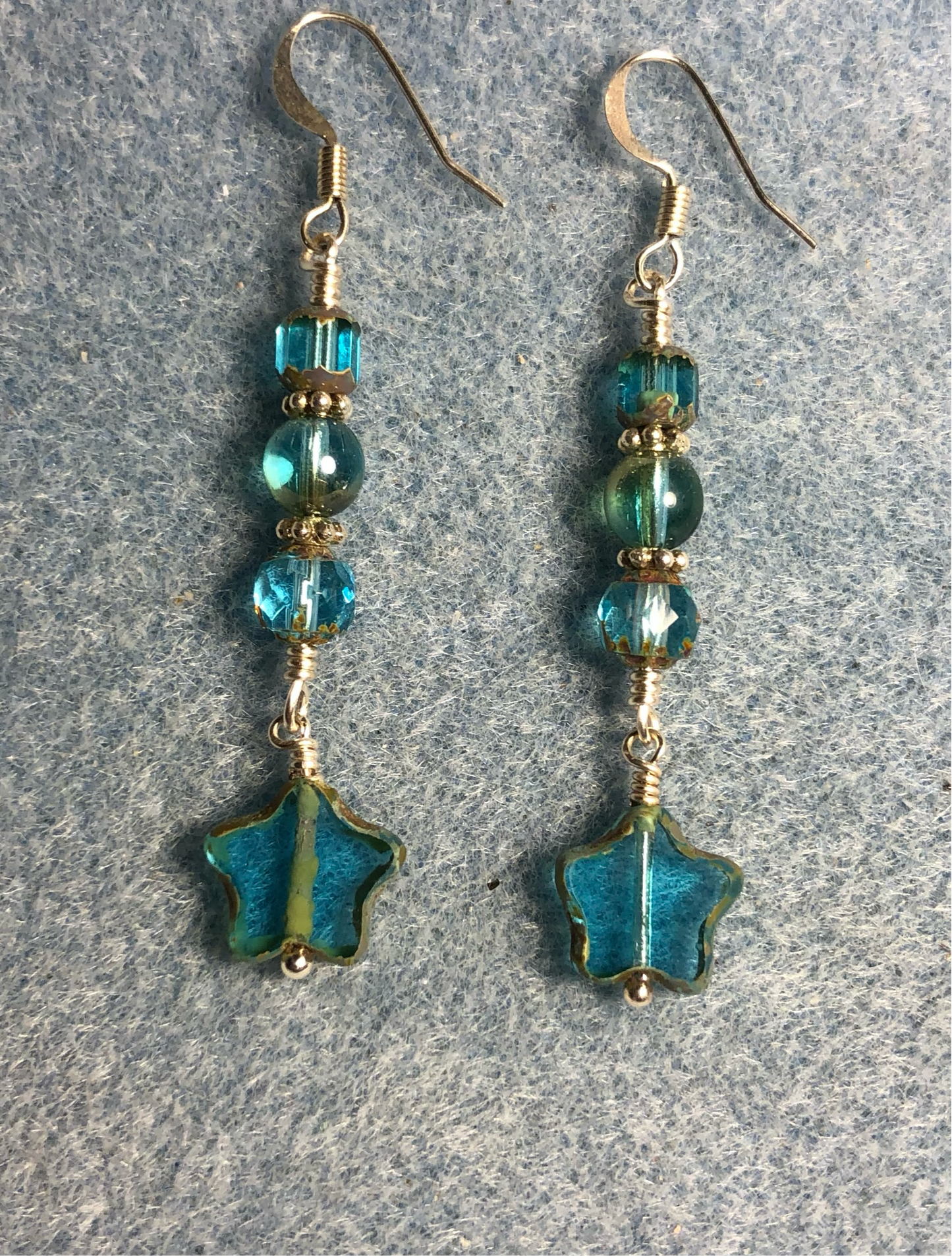 Small translucent turquoise green Czech glass star bead earrings adorned with turquoise green Czech glass beads.