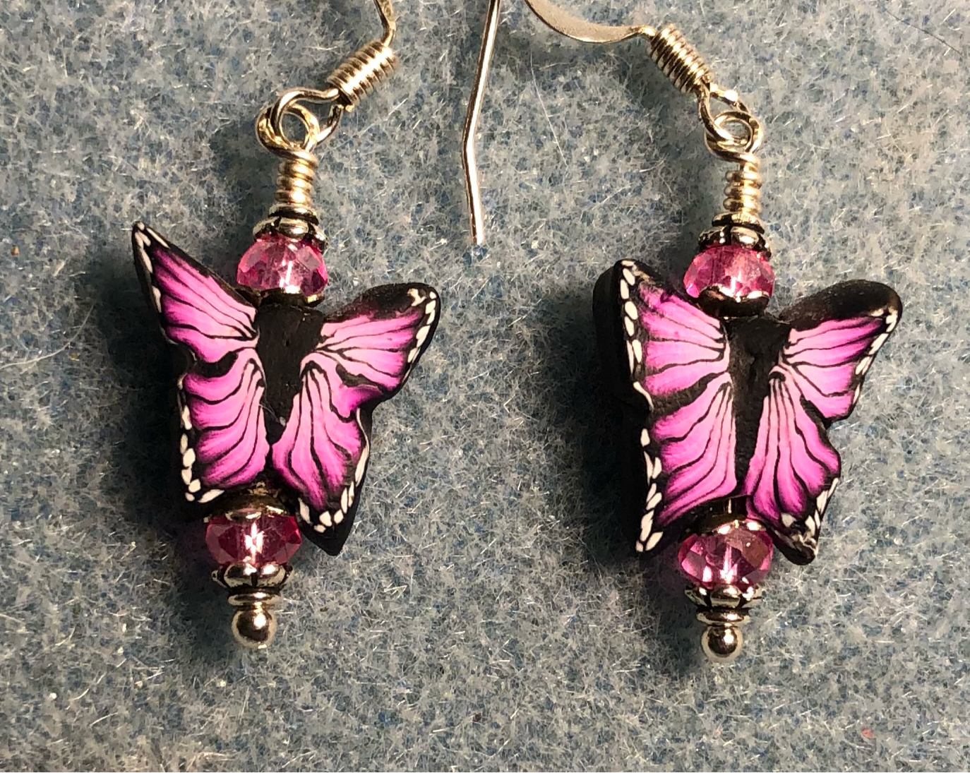 Hot pink and black polymer clay butterfly bead earrings adorned with hot pink Chinese crystal beads.