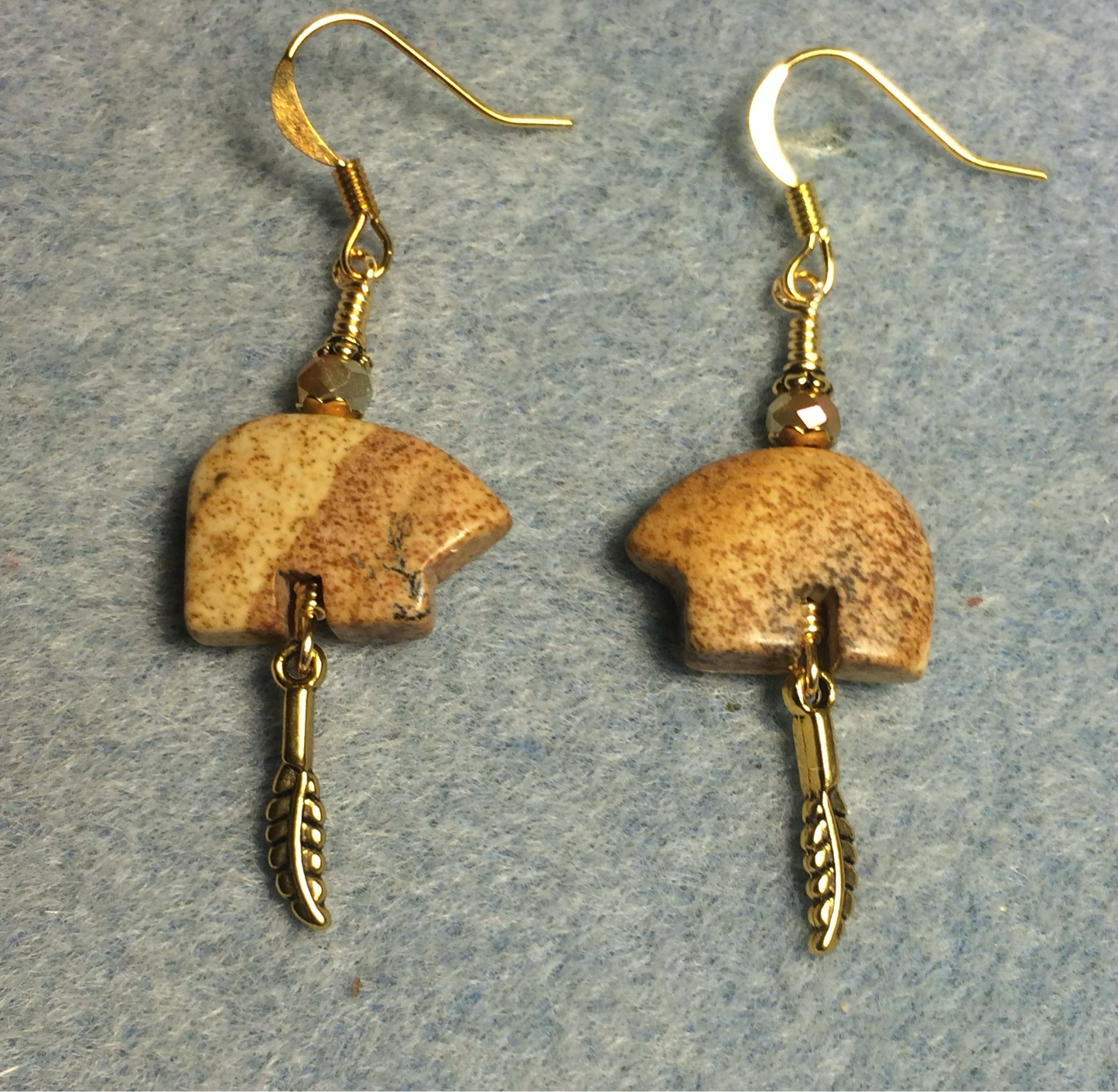 Picture jasper gemstone Zuni bear fetish bear earrings adorned with tan crystal beads and tiny gold feather charms.
