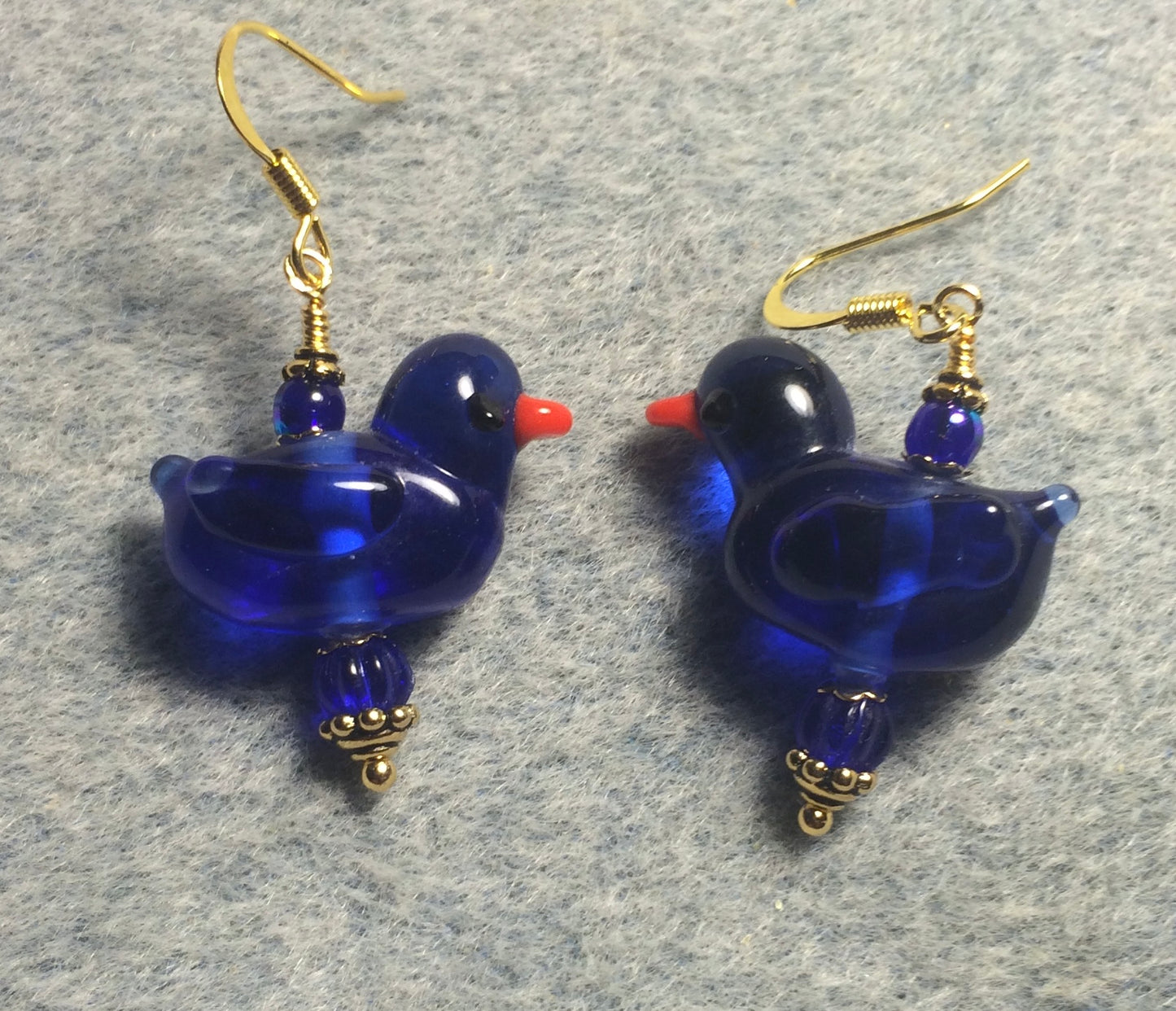 Translucent cobalt blue lamp work duck bead earrings adorned with cobalt blue Czech glass beads.