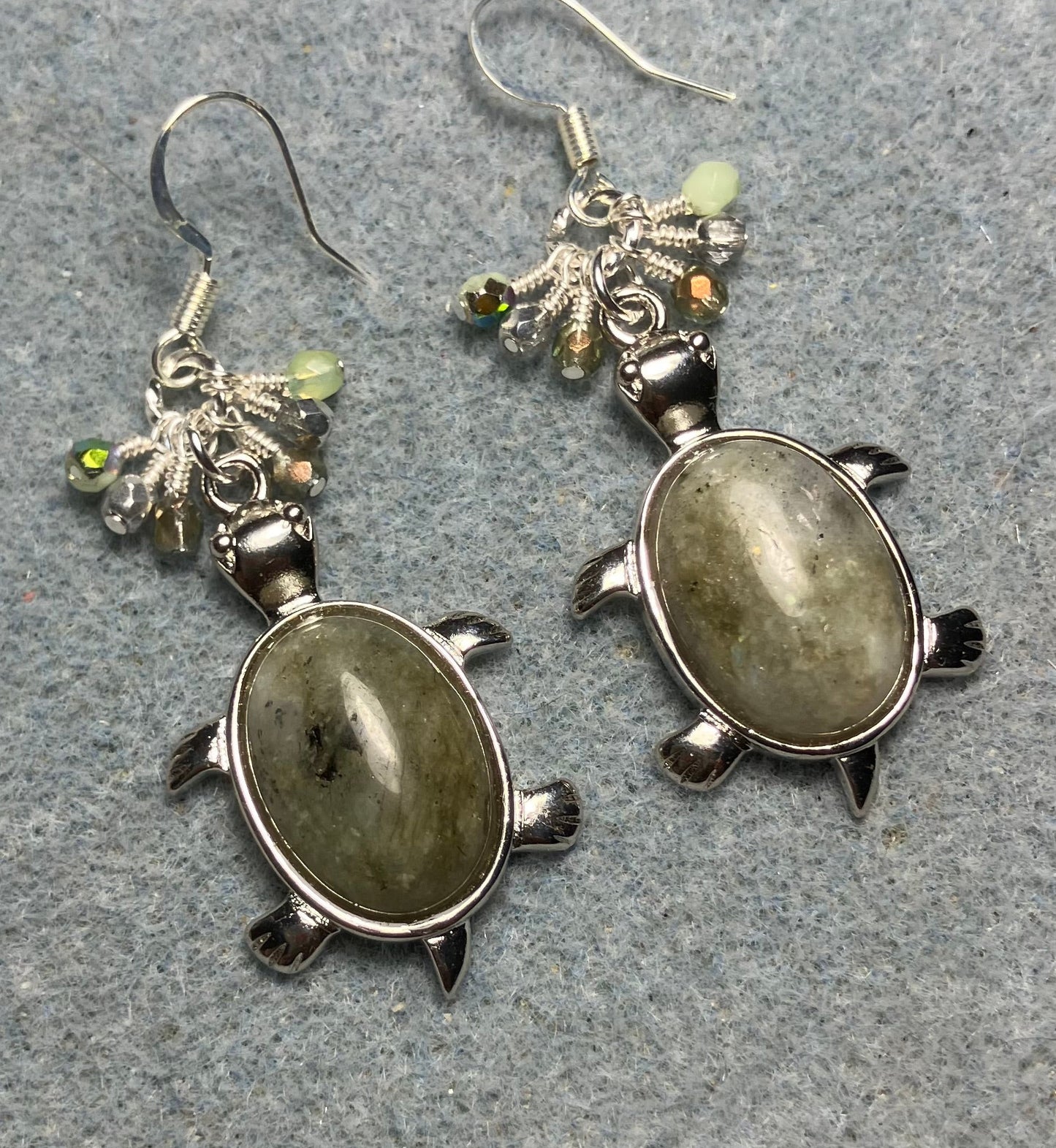 Large silver and green agate gemstone turtle charm earrings adorned with small dangling green and silver Czech glass beads.